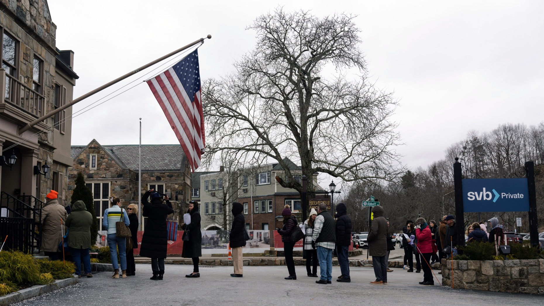 Customers wait in line outside a Silicon Valley Bank branch in Wellesley, Mass., on Monday. Photo by Bloomberg.