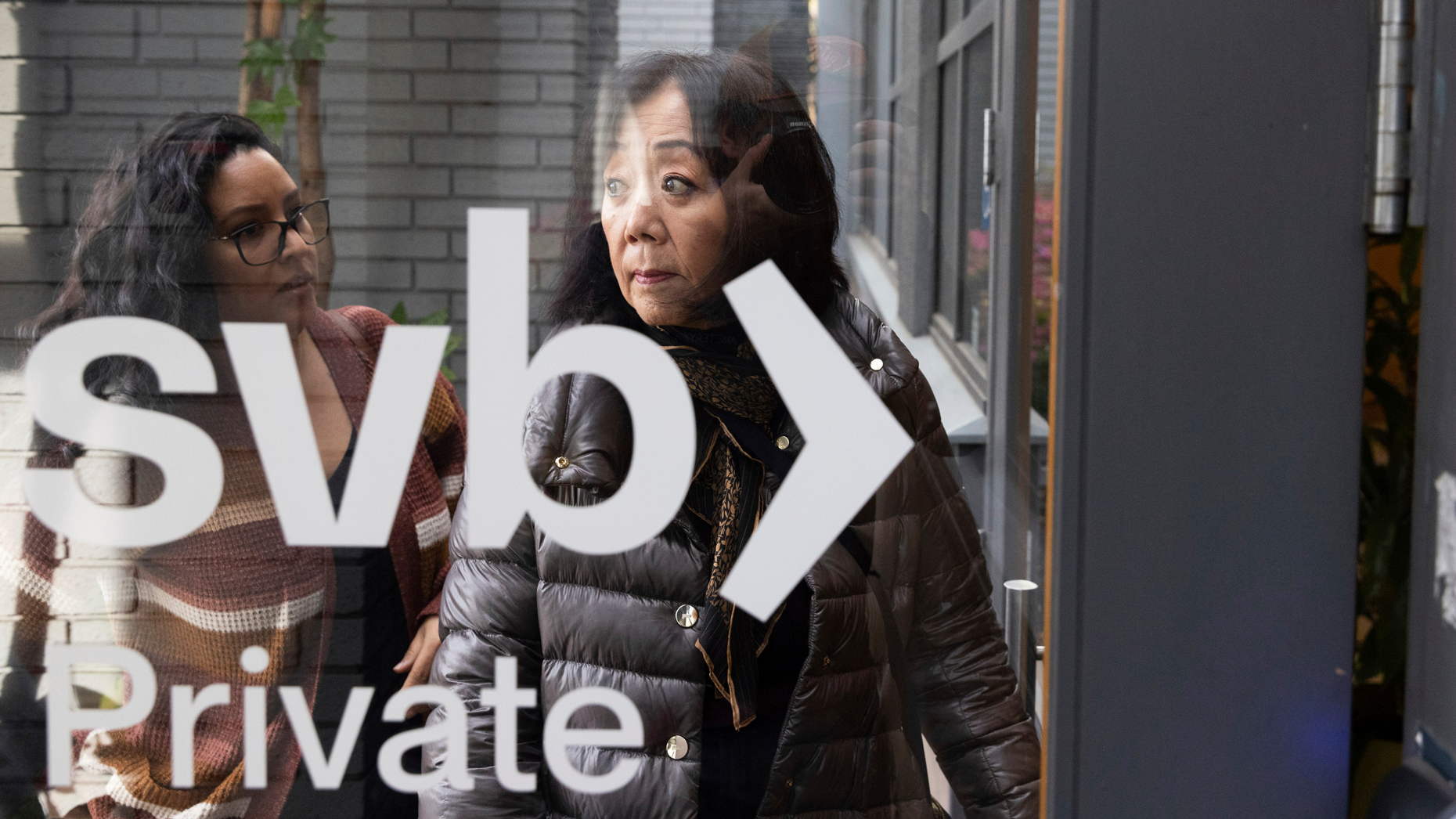 Two Silicon Valley Bank customers enter a branch in Palo Alto, Calif., on Monday. Photo by AP.