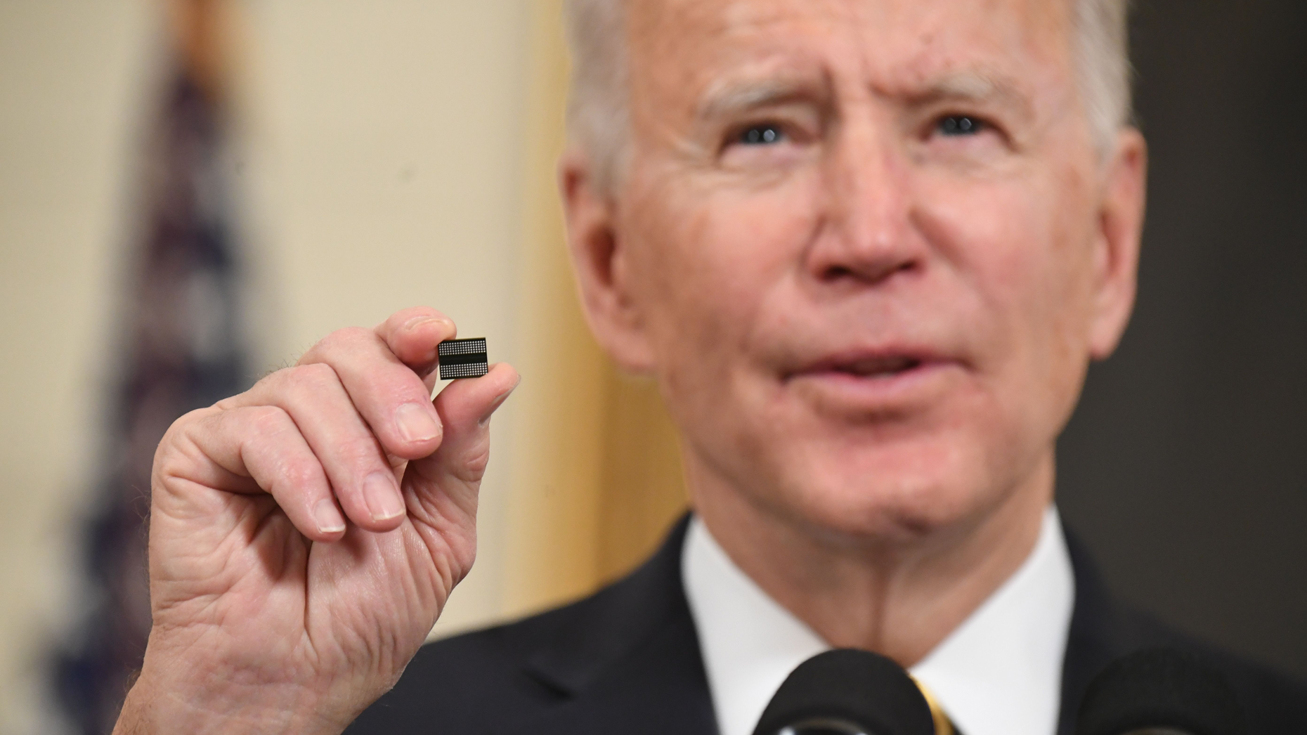President Joe Biden holds a microchip. Photo by Getty.