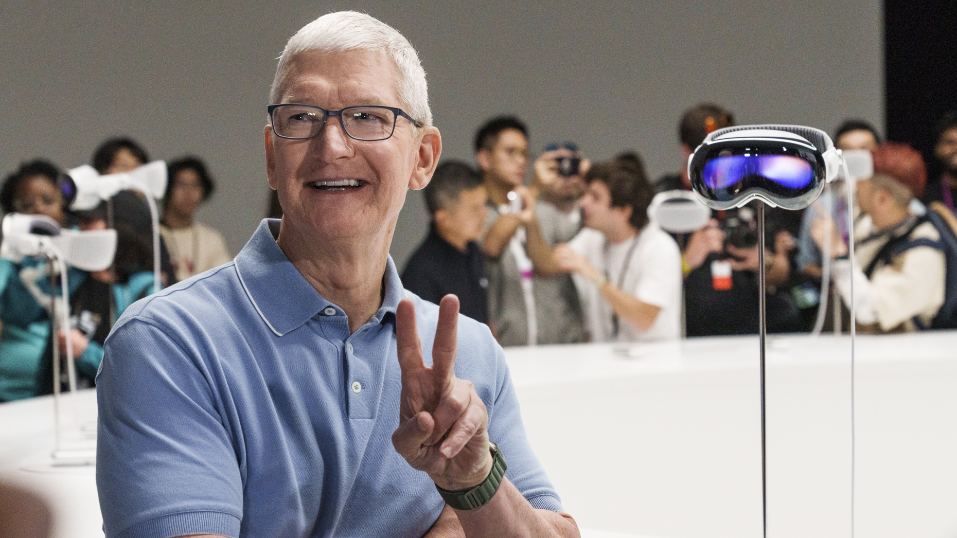 Apple CEO Tim Cook and a Vision Pro headset during an Apple conference in June. Photo by Bloomberg via Getty