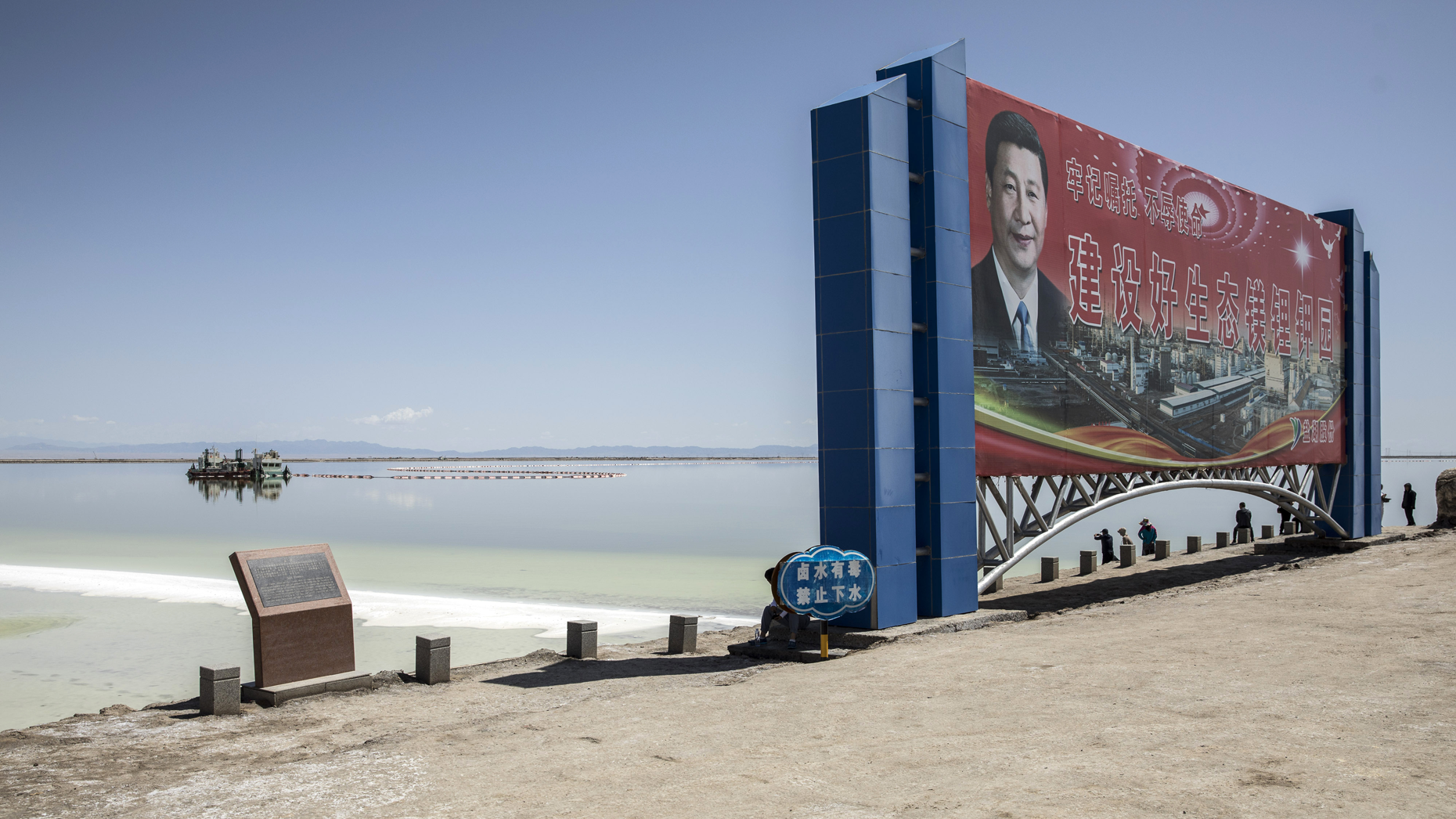 At a lithium evaporation pond in Golmud, China, a billboard promotes the production of battery metals and minerals. Photo: Qilai Shen/Bloomberg/Getty.