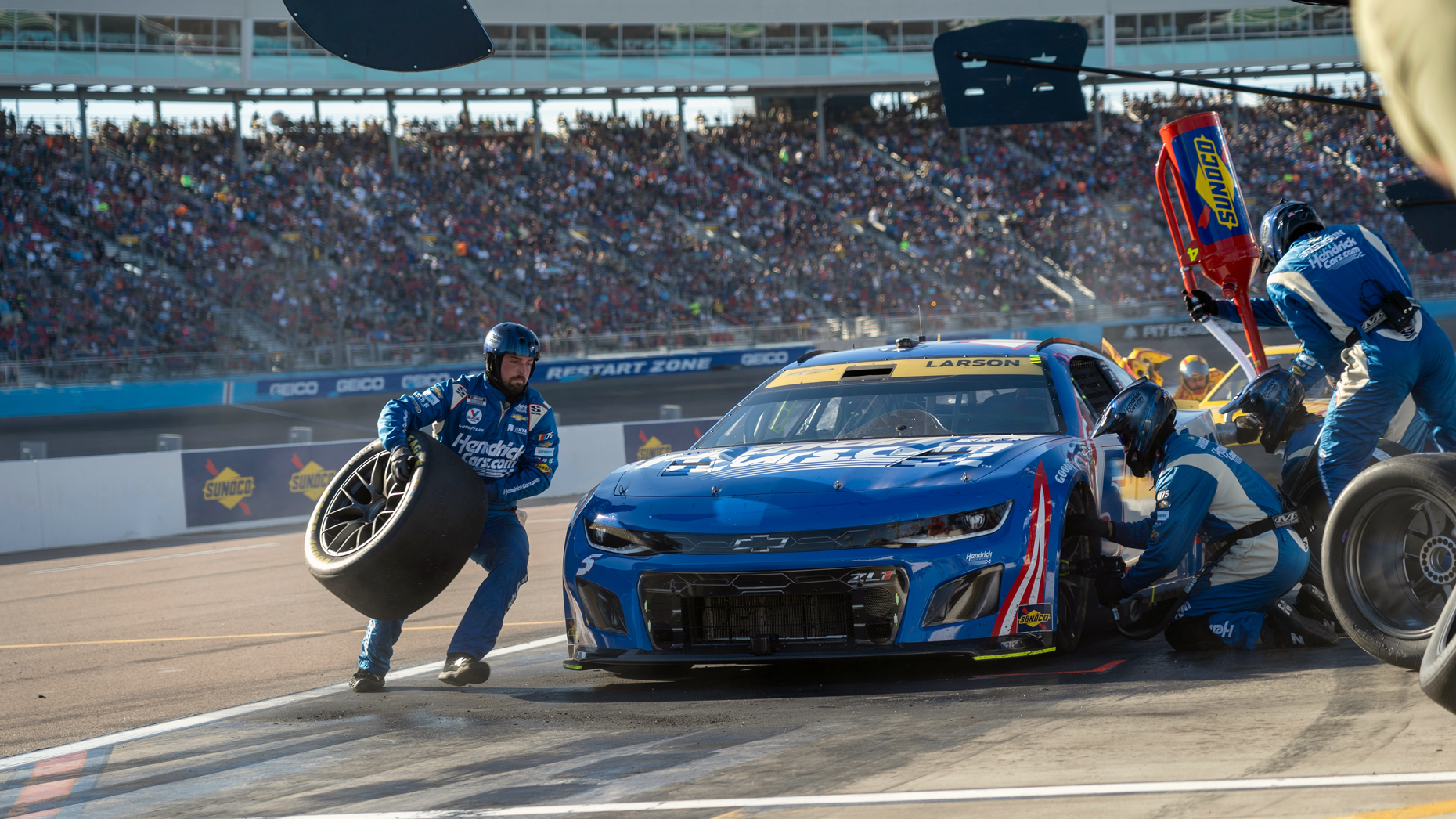 A driver and crew make a pit stop at the NASCAR Cup Series Championship at the Phoenix Raceway in November 2023. Photo by Grindstone Media Group via Shutterstock.