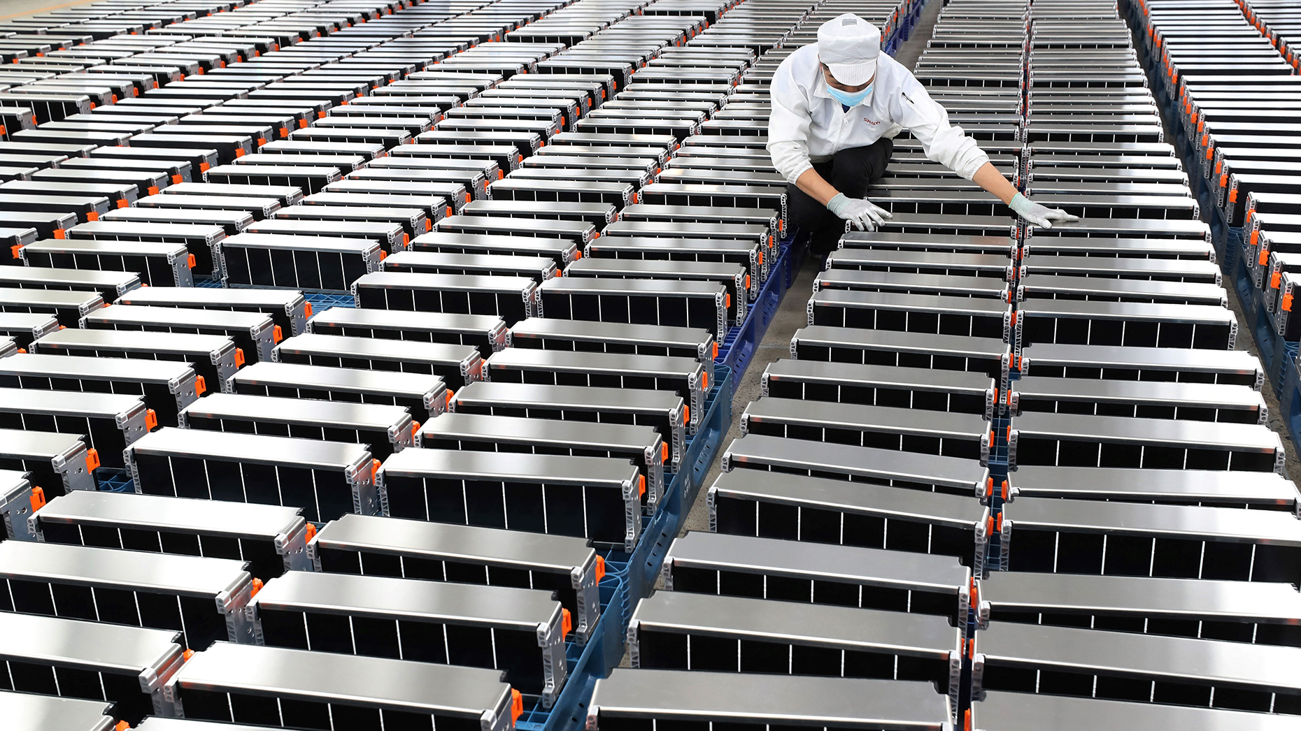 A Chinese worker stores electric vehicle batteries. Photo: Getty