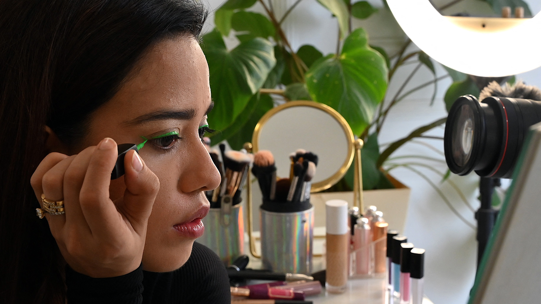 Beauty influencer Debasree Banerjee doing her makeup live on YouTube. Photo via Sujit Jaiswal/AFP via Getty Images.