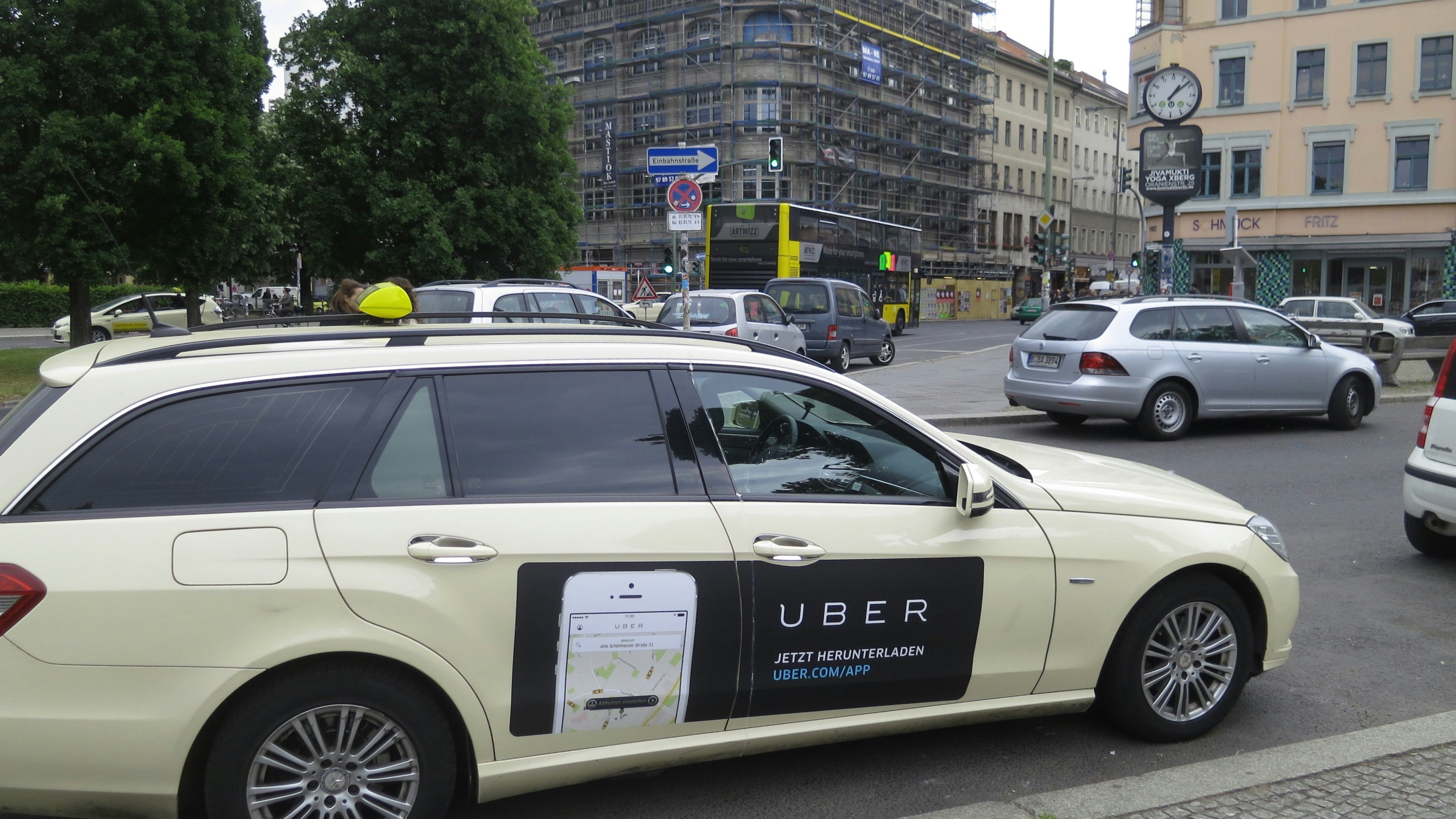 An Uber ad on a taxi. Photo by Flickr/Alper Cugun.