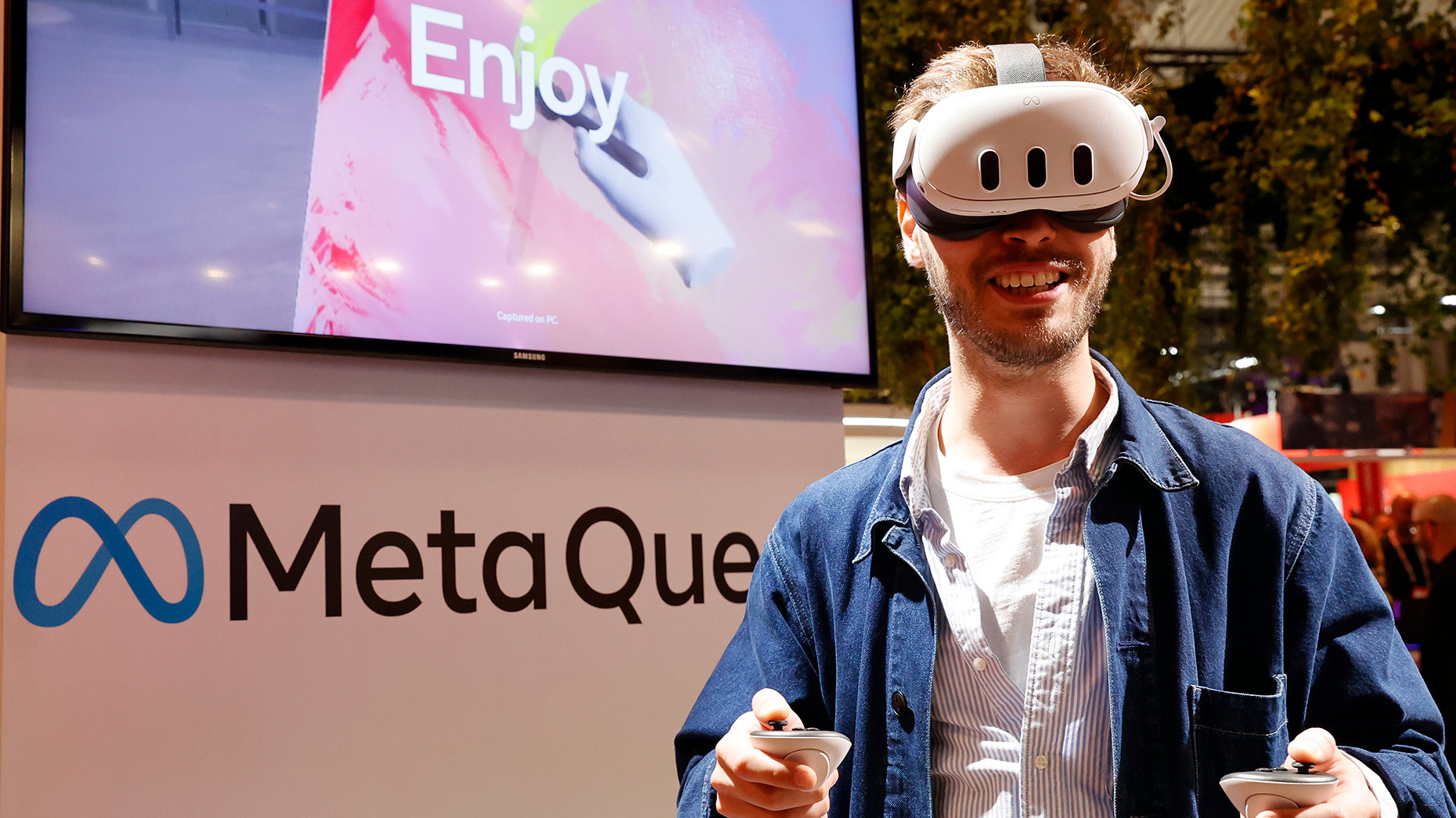 A visitor wears a virtual reality headset Meta Quest as he takes part in an immersive experience stand in Paris last May. Photo by Getty.
