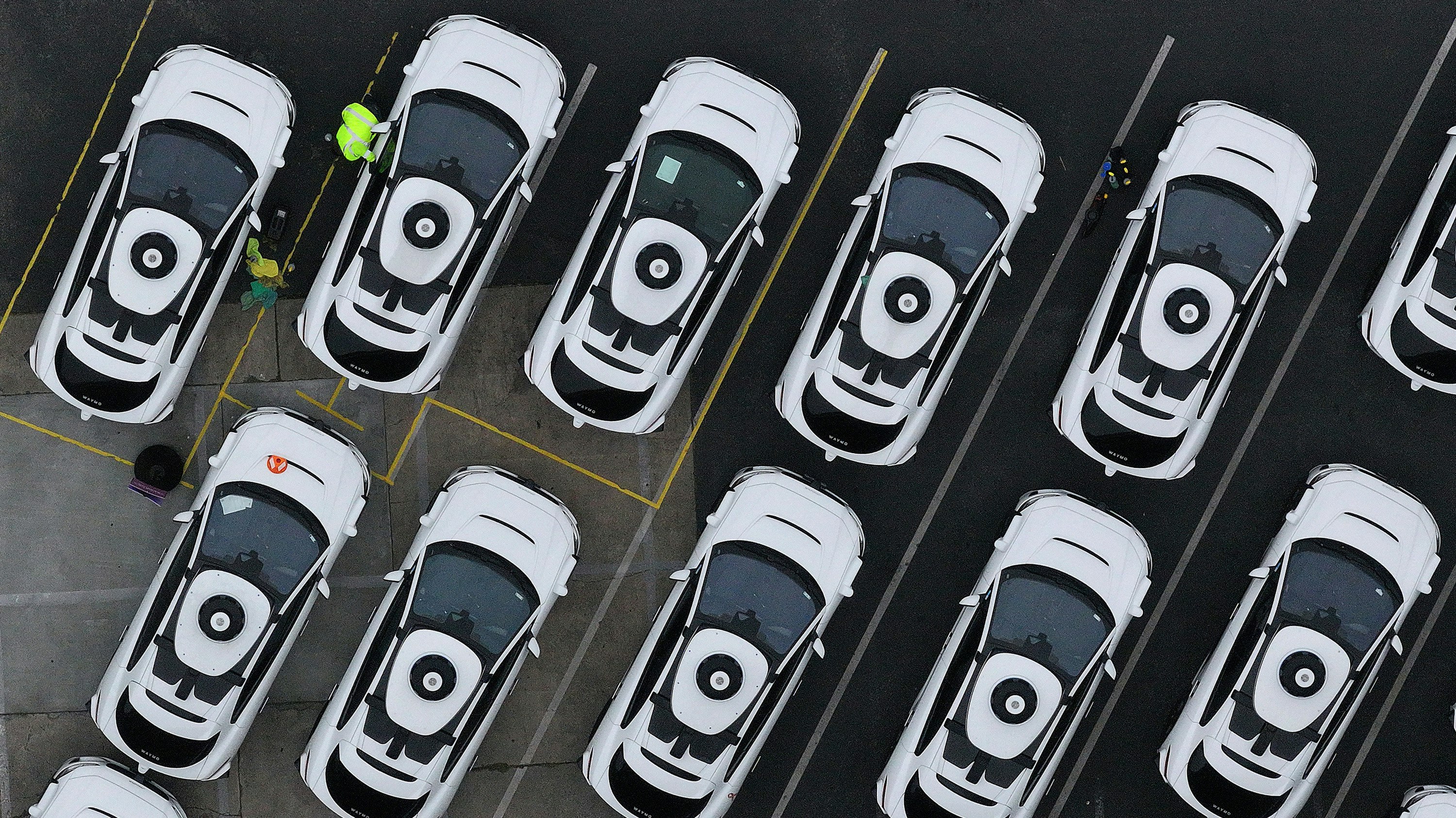 Waymo cars are seen parked at a Waymo facility on June 10 in San Francisco.