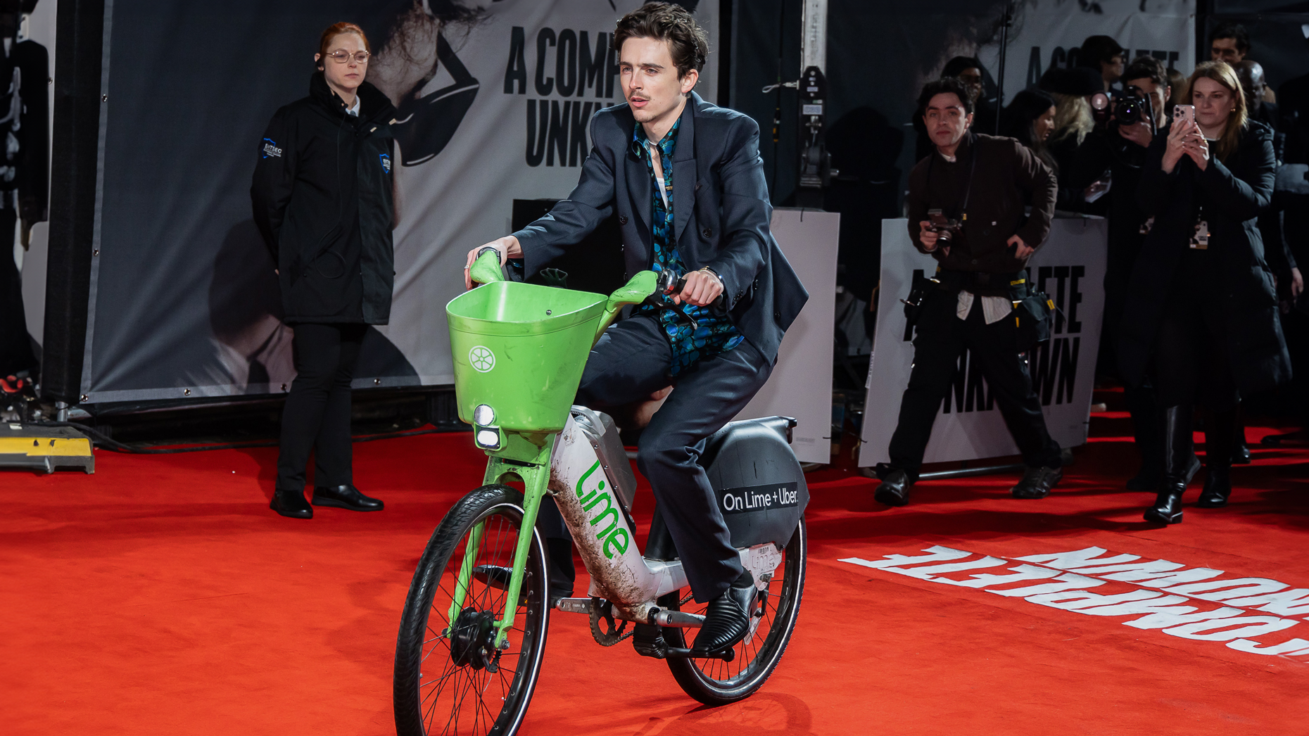 Timothée Chalamet enters a movie premiere in London on a Lime Bike in January. Photo via Getty.