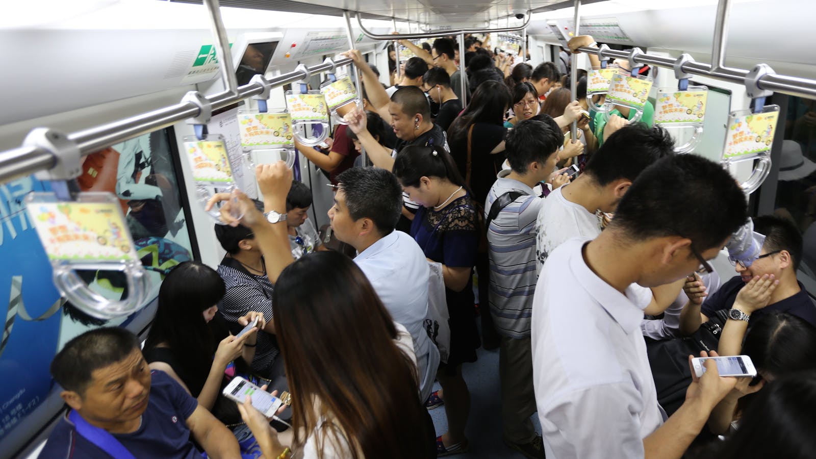 Chinese commuters using WeChat on the Beijing subway. Photo by Hao Xia.
