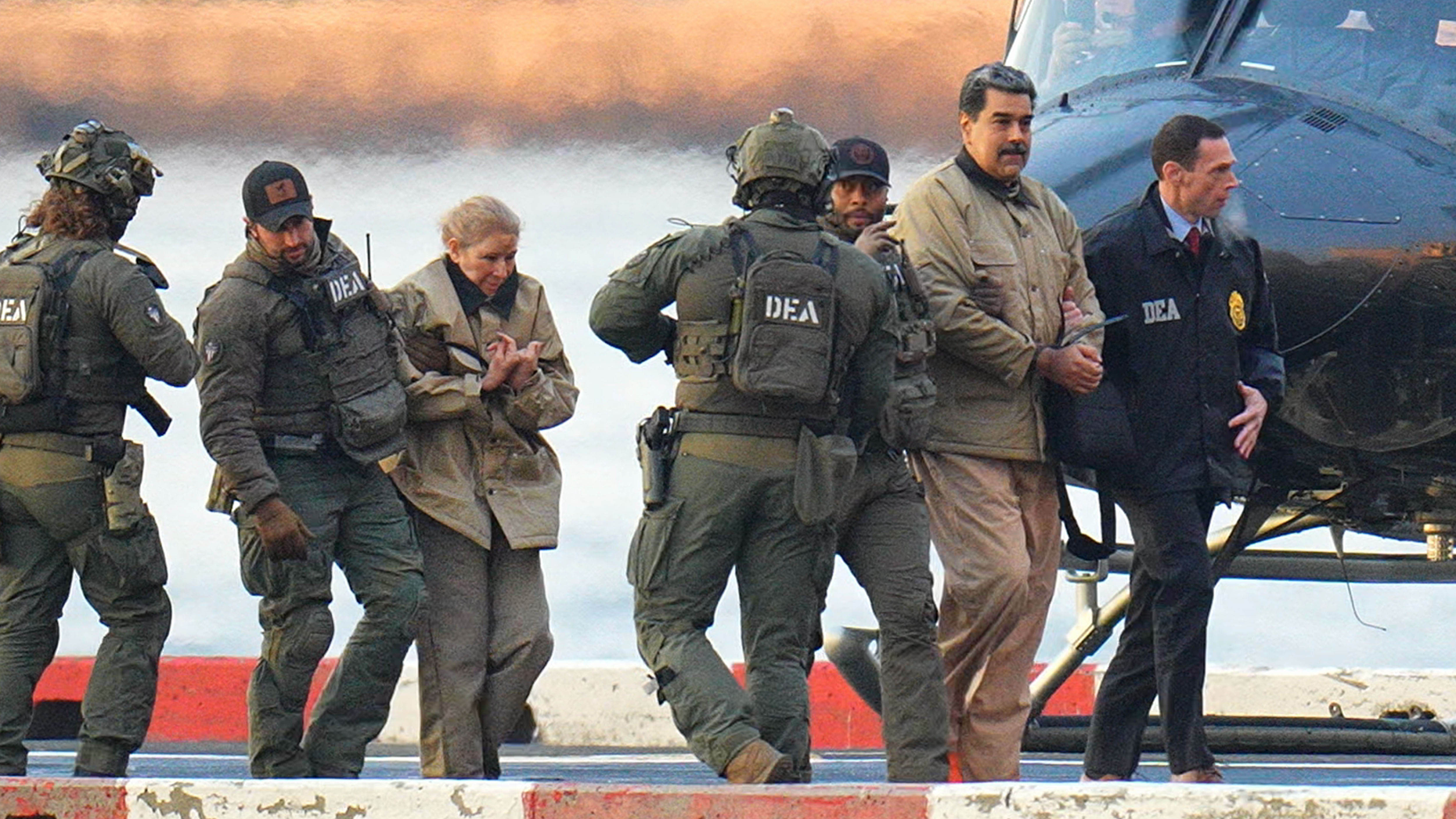 Nicolas Maduro and his wife, Cilia Flores, in handcuffs after landing at a Manhattan helipad. XNY/Star Max/GC Images via Getty.