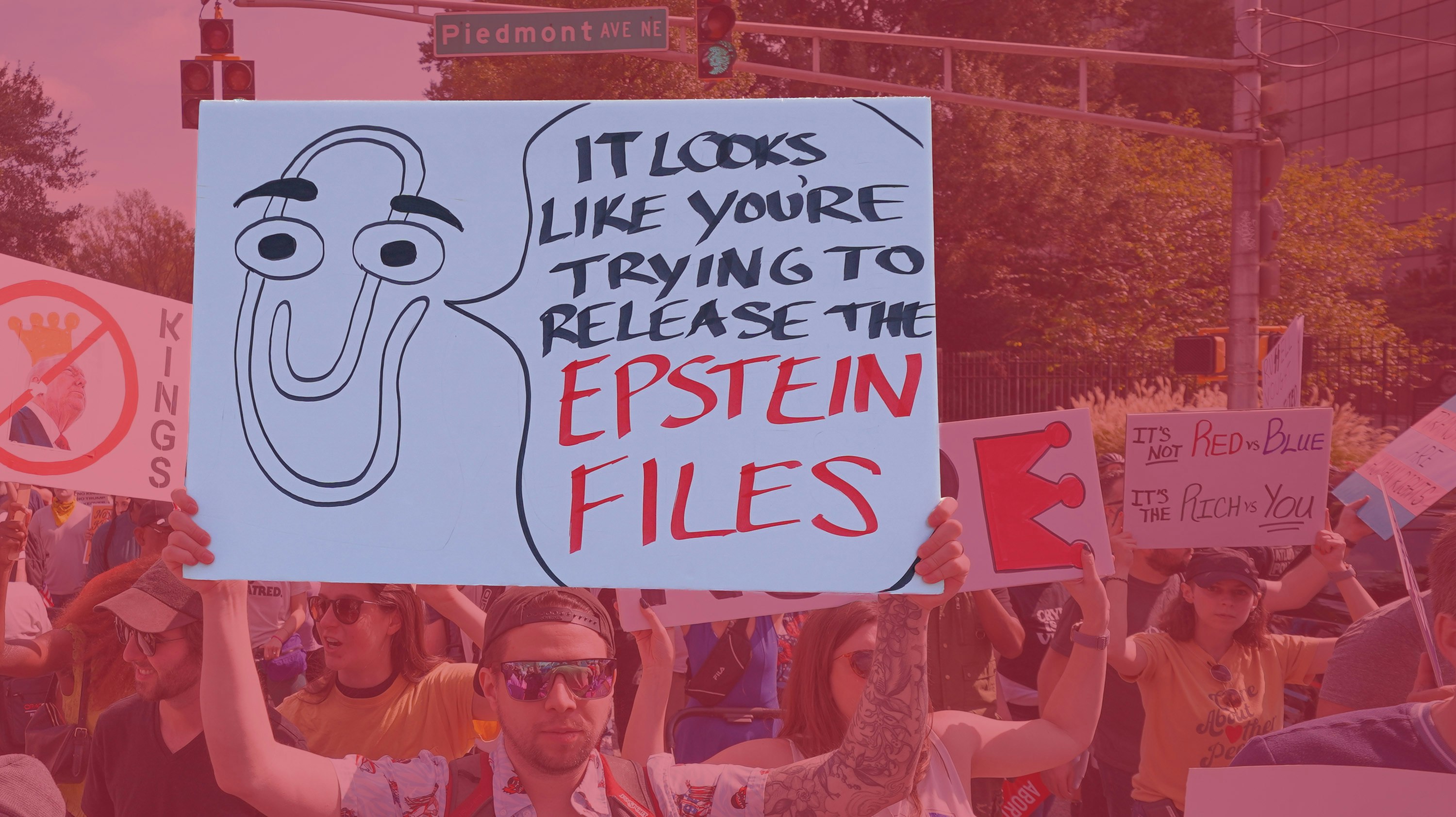 Demonstrators hold protest signs in Atlanta in October, 2025. Photo by Julia Beverly/Getty Images (edited)