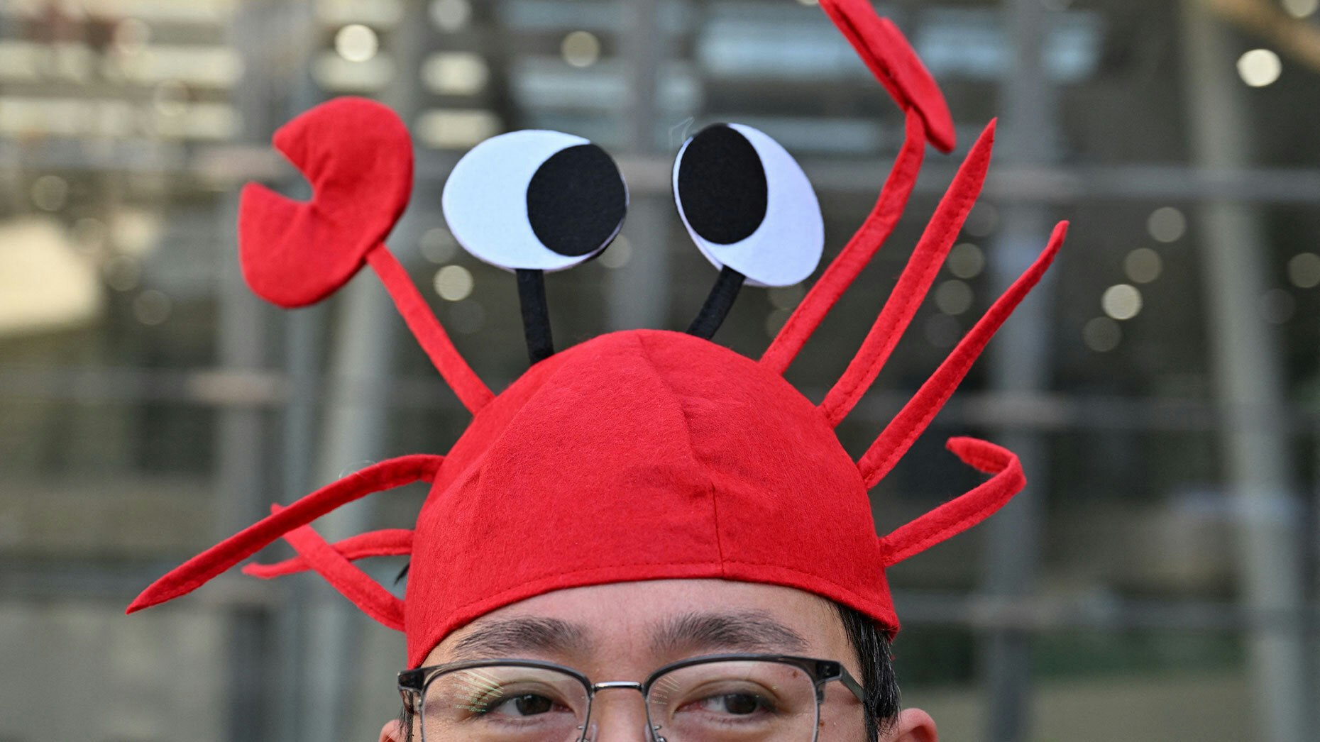A man wears a lobster hat that represents OpenClaw at Baidu's headquarters in Beijing. Photo by Adek Berry/ Getty Images)
