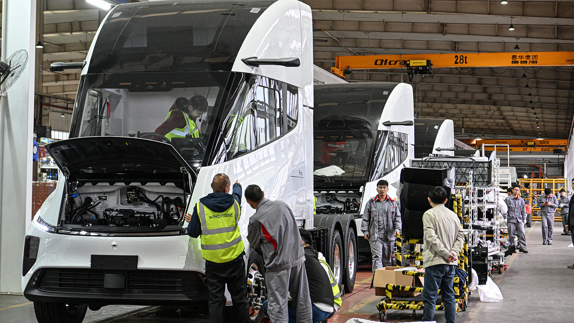 Windrose employees working on an electric truck assembly line. Photo via Getty Image