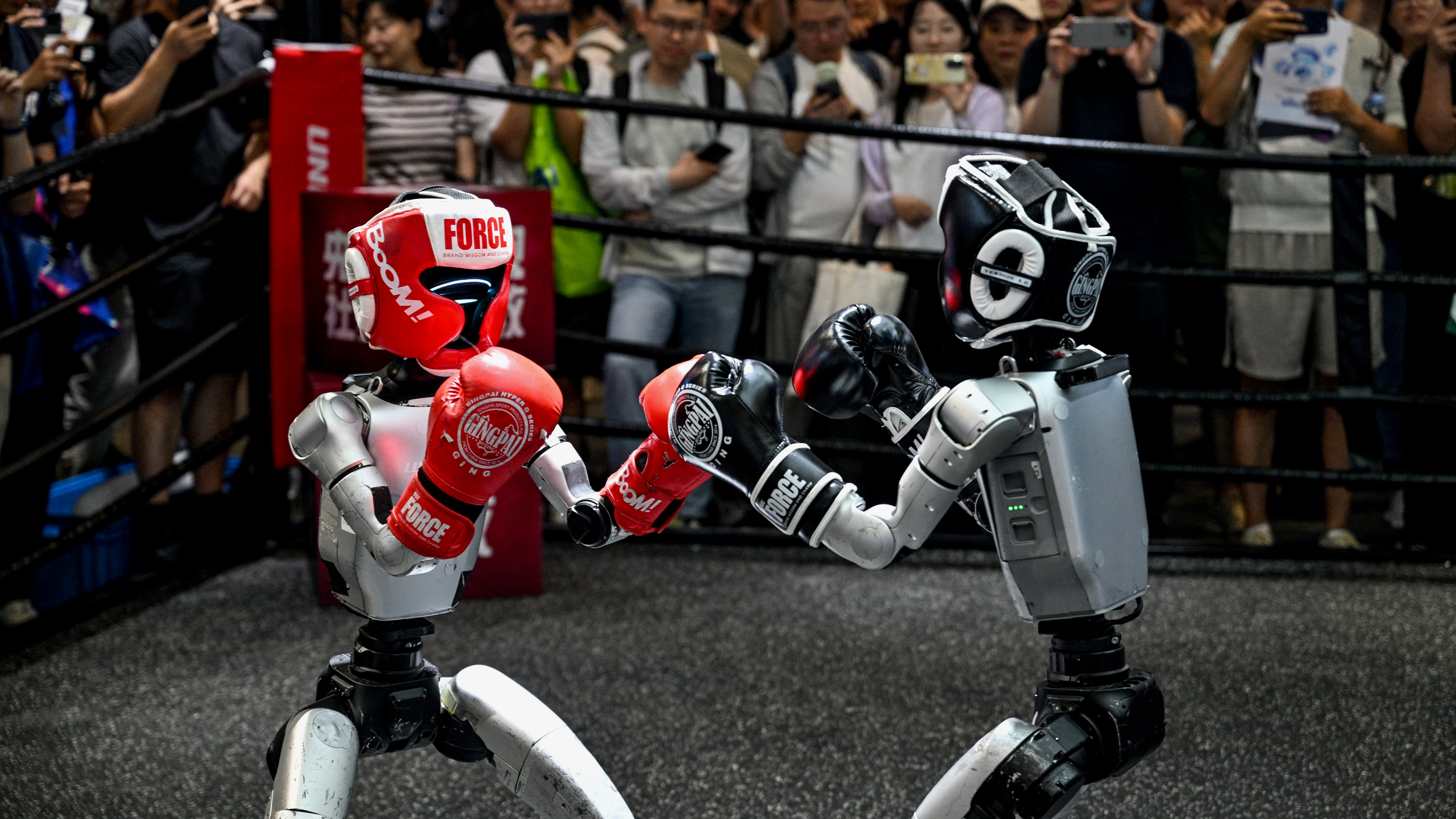 Boxing robots made by China's Unitree. Photo: Hector Retamal/AFP/Getty
