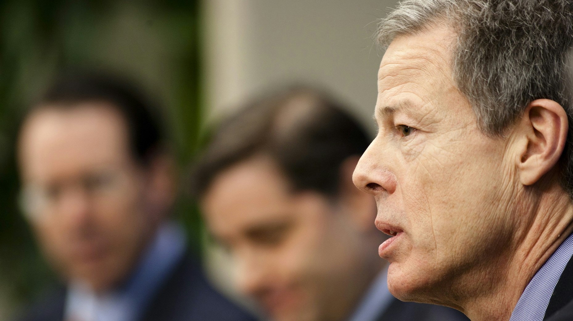 Time Warner CEO Jeff Bewkes with AT&T CEO Randall Stephenson in the background. Photo by Bloomberg.