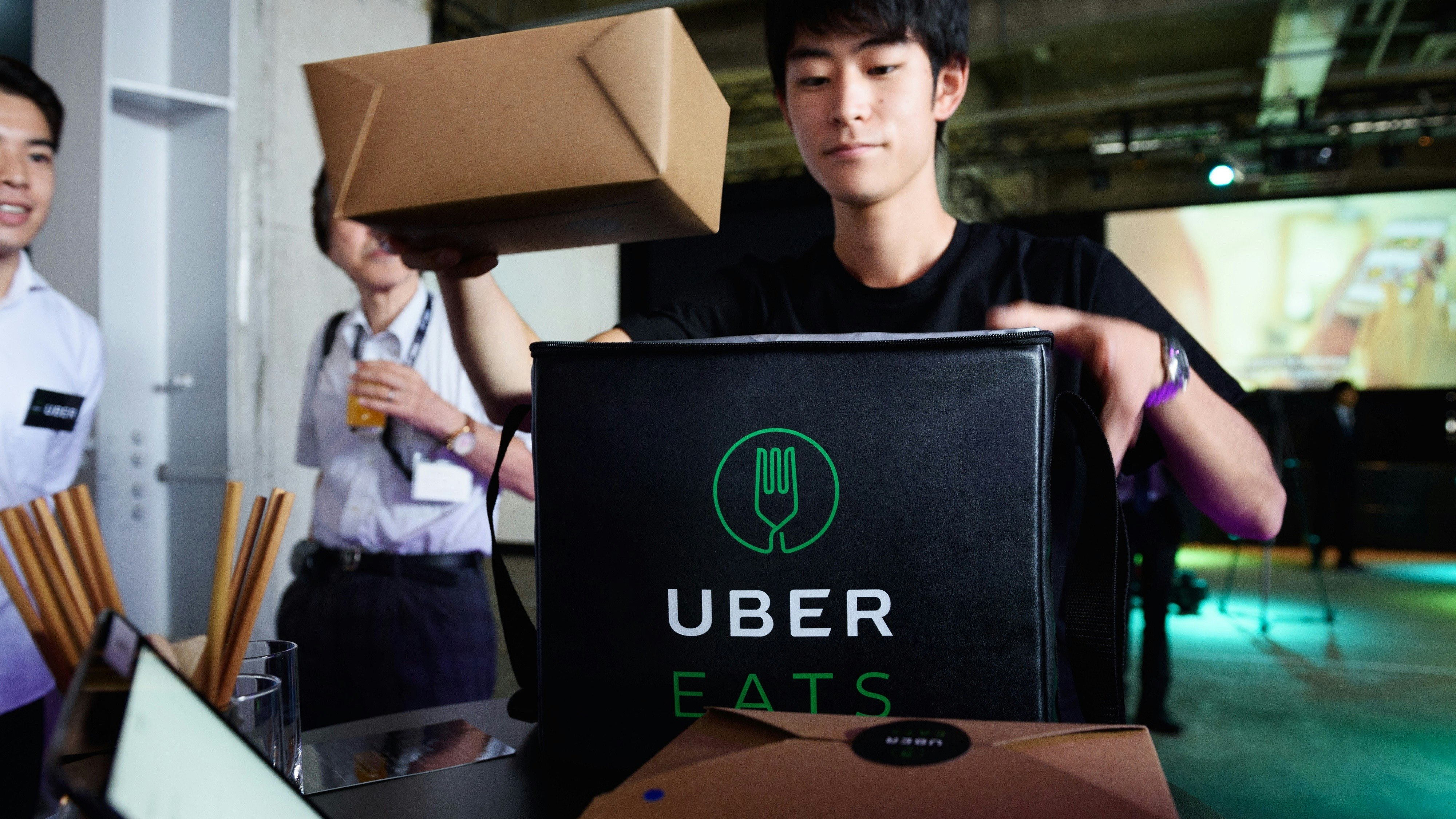 An UberEats delivering takeaway food at a launch event in Japan. Photo by Bloomberg.