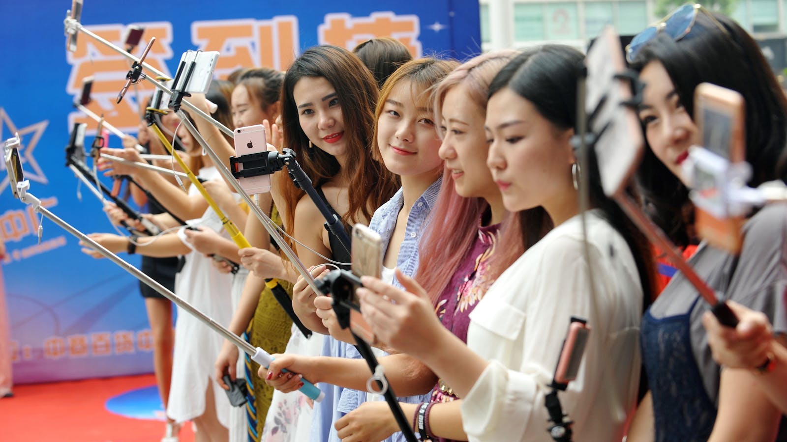 A group of women live streaming at a shopping mall in China last September. Photo by AP.