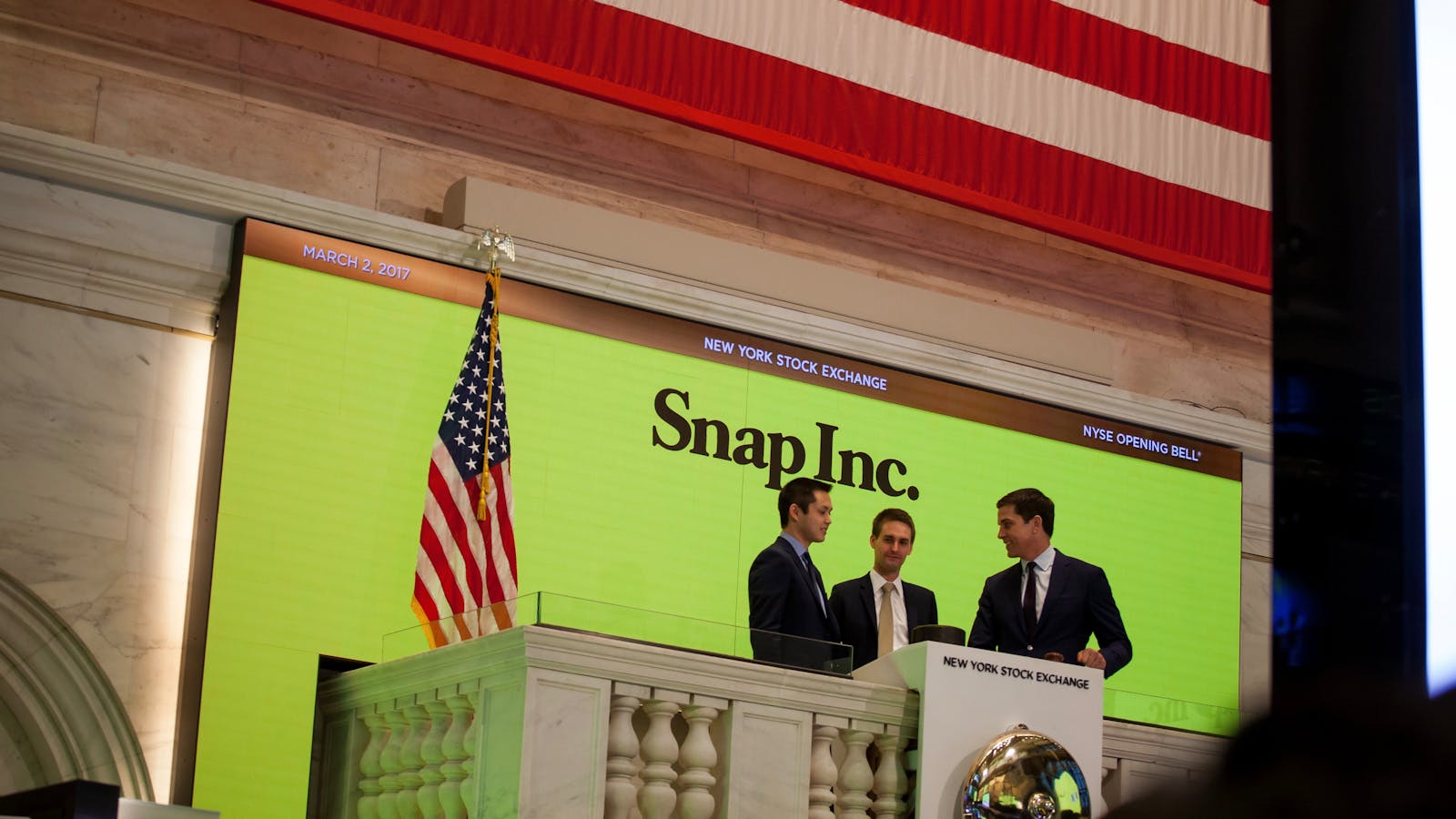 Snap co-founders Robert Murphy and Evan Spiegel at the New York Stock Exchange on Snap's IPO day, with NYSE President Tom Farley. Photo by Bloomberg.