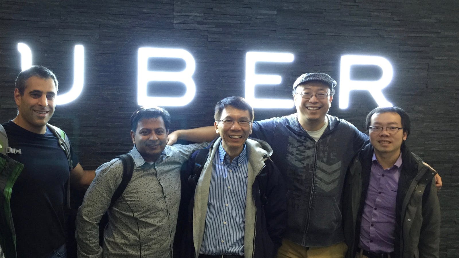 Uber's Chief Technology Officer Thuan Pham, center, with fellow engineers.