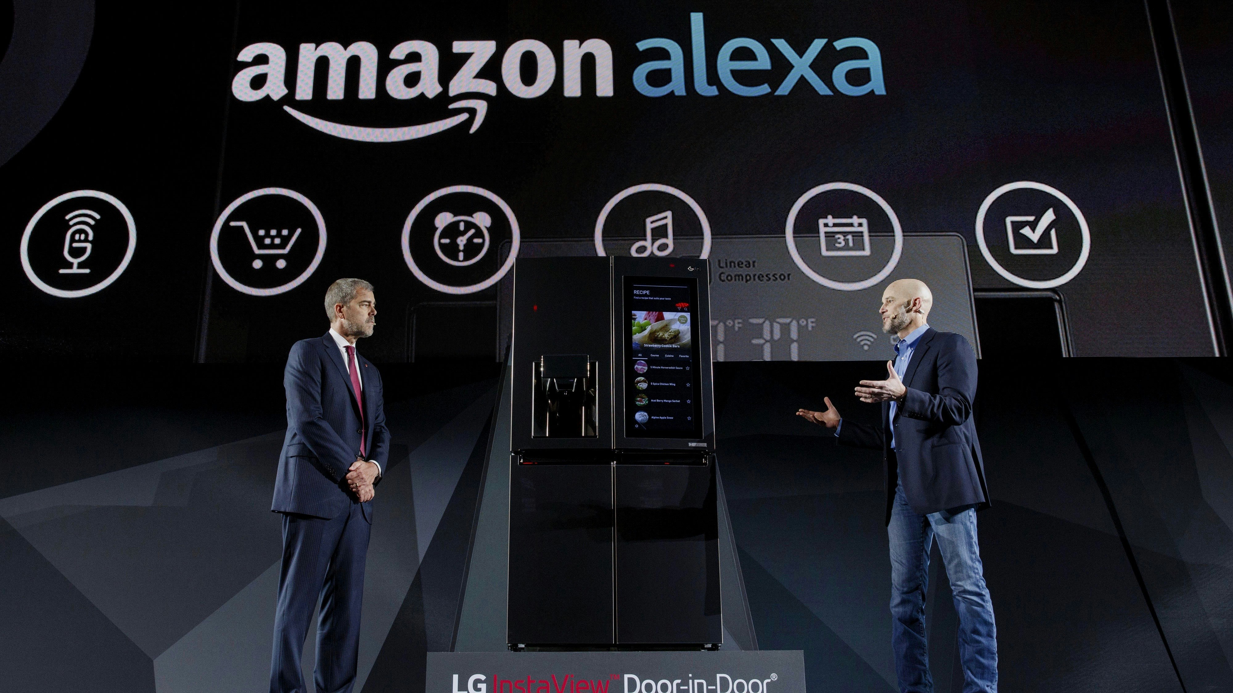 David VanderWaal, vice president of marketing for LG Electronics USA and Michael George, vice president of Alexa, Echo, and Appstore at Amazon, discussing an LG-Amazon Alex partnership at CES this year. Photo by Bloomberg.