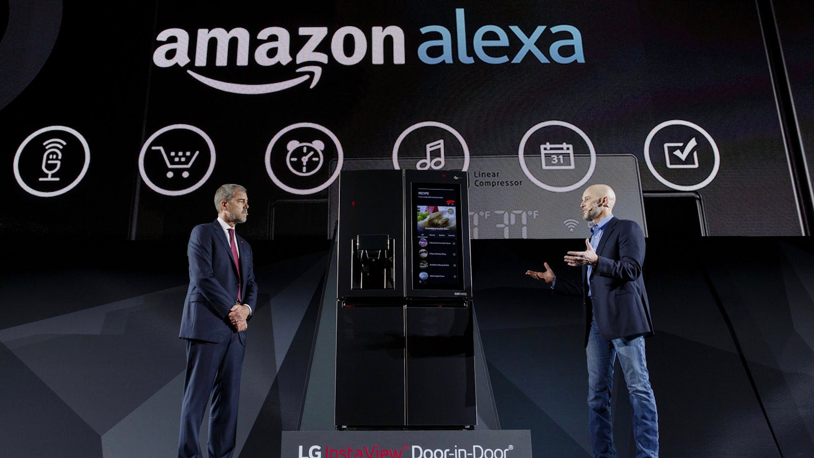 David VanderWaal, vice president of marketing for LG Electronics USA and Michael George, vice president of Alexa, Echo, and Appstore at Amazon, discussing an LG-Amazon Alex partnership at CES this year. Photo by Bloomberg.
