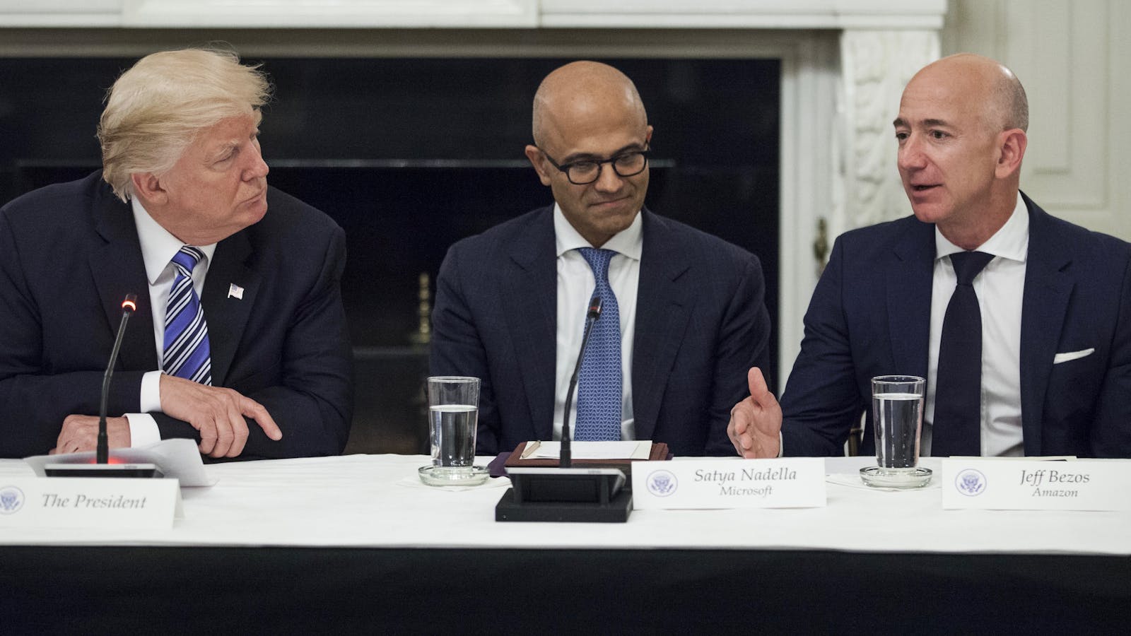 President Trump with Microsoft CEO Satya Nadella and Amazon CEO Jeff Bezos at a White House meeting in June. Photo by Bloomberg.