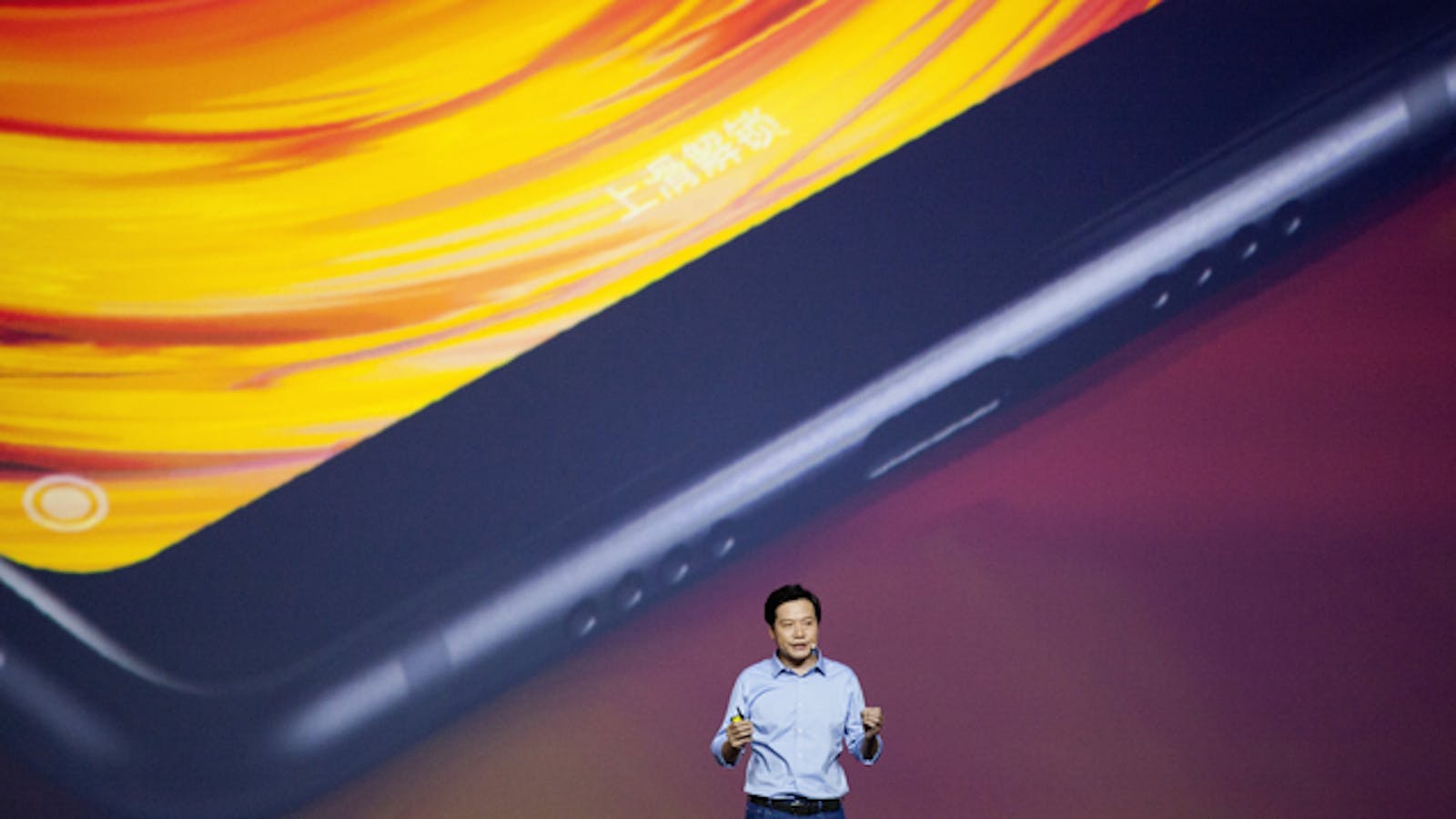 Xiaomi CEO Lei Jun unveiling a new smartphone in China in September. Photo by Bloomberg.