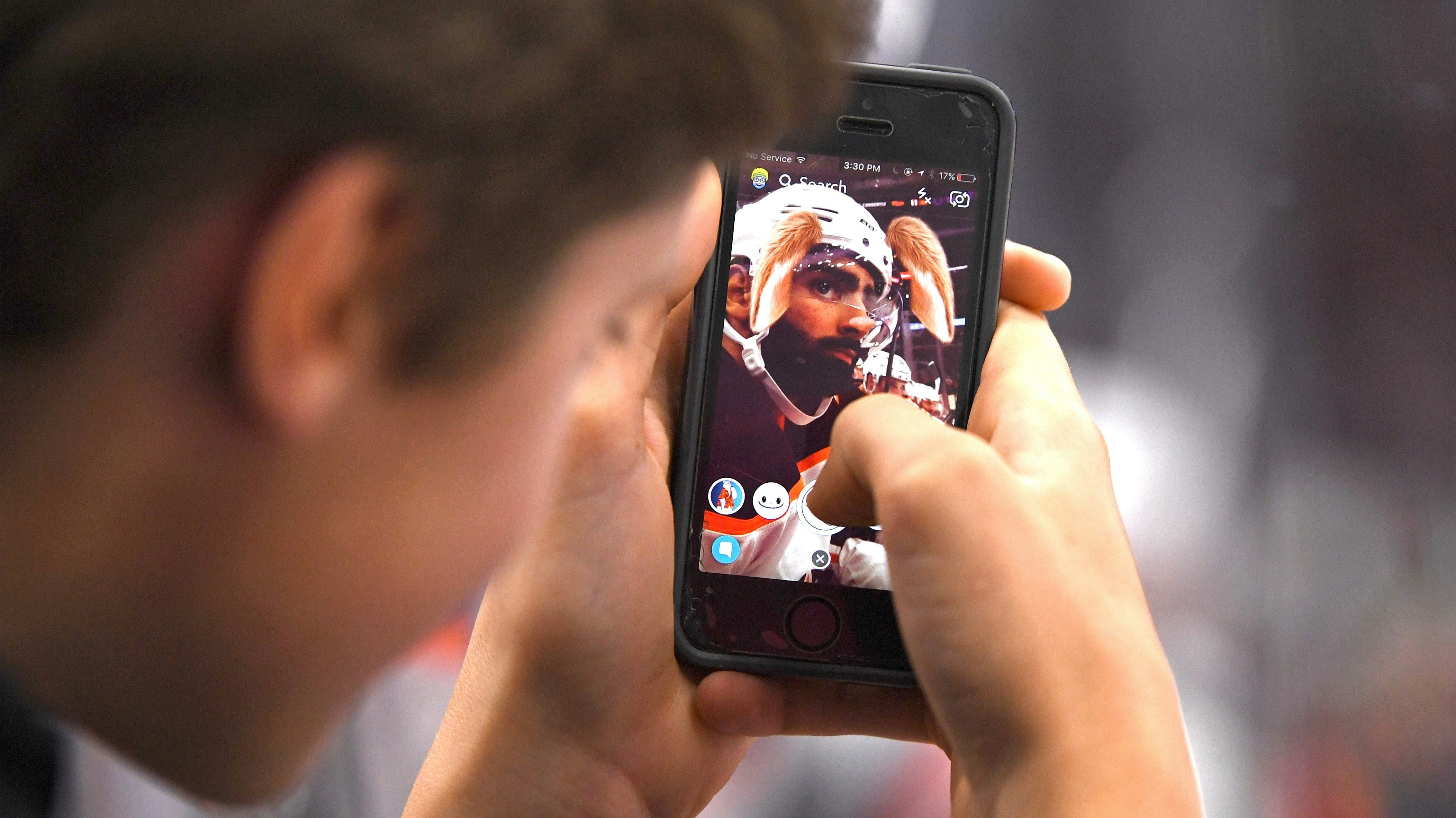 A Snapchat user putting a filter on Edmonton Oilers left wing Jujhar Khaira during a game earlier this month. Photo by AP.