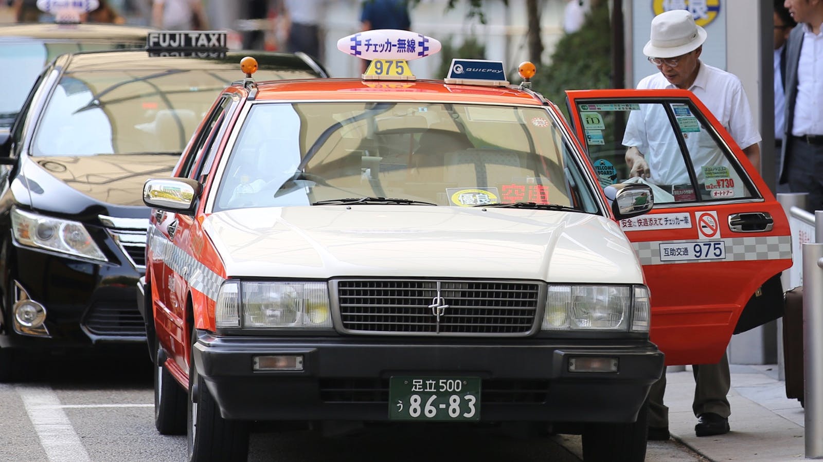 Taxis at a taxi stand outside a train station in Tokyo. Photo: Bloomberg