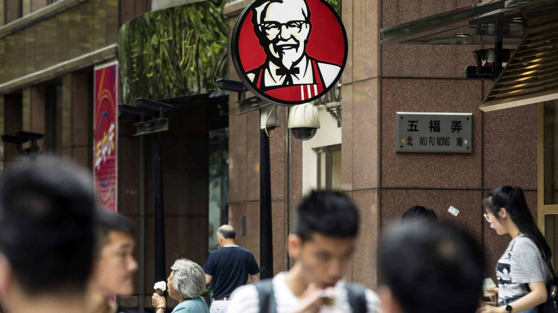 Pedestrians walk past a Yum Brands KFC restaurant in Shanghai. Photo: Bloomberg