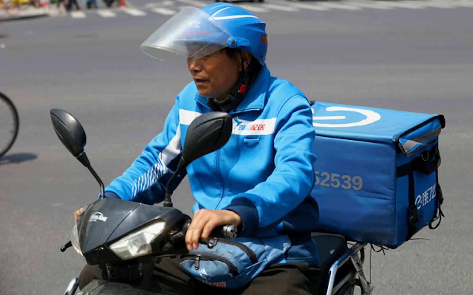 An Ele.me delivery courier in Shanghai in April. Photo by AP