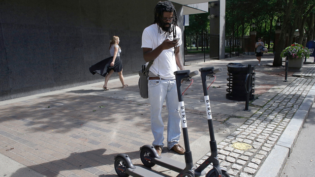 A man prepared to ride a Bird scooter in Providence, R.I., in July. Photo: AP