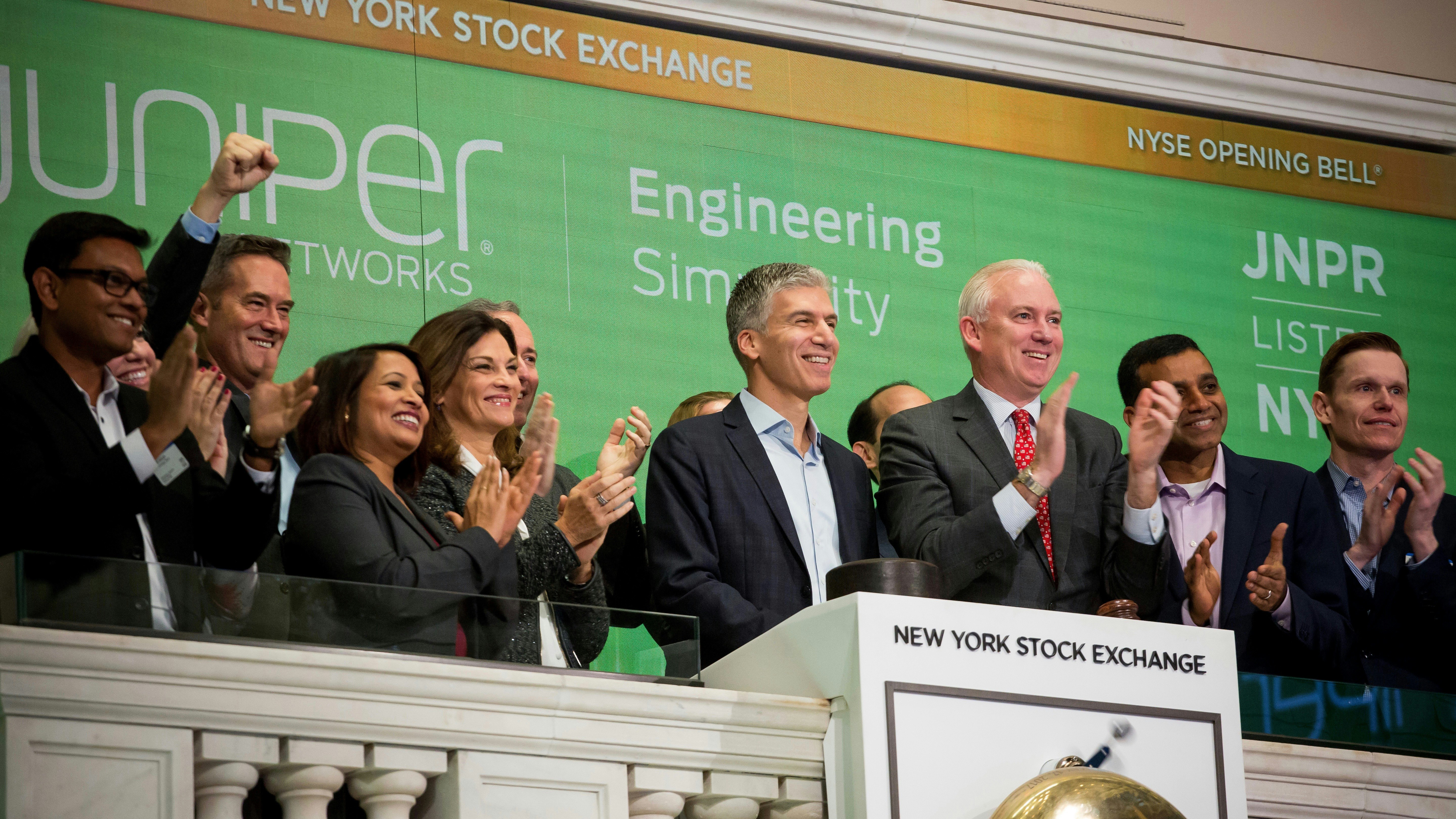 Juniper CEO Rami Rahim, center, at the New York Stock Exchange last month. Photo by Bloomberg 