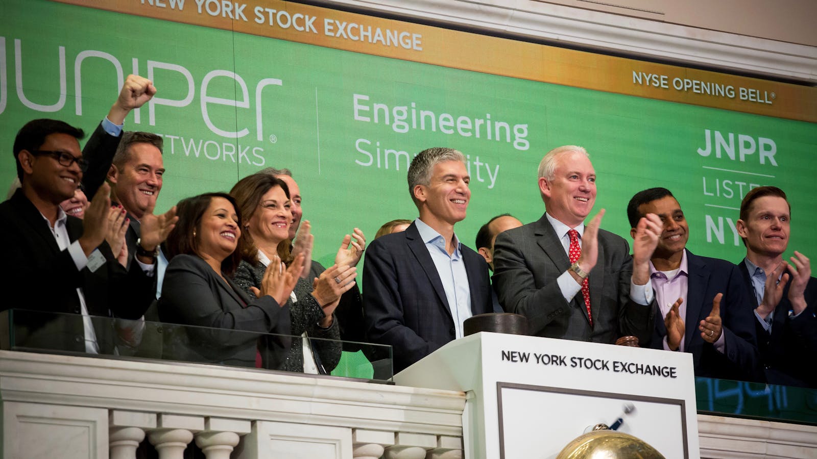 Juniper CEO Rami Rahim, center, at the New York Stock Exchange last month. Photo by Bloomberg 