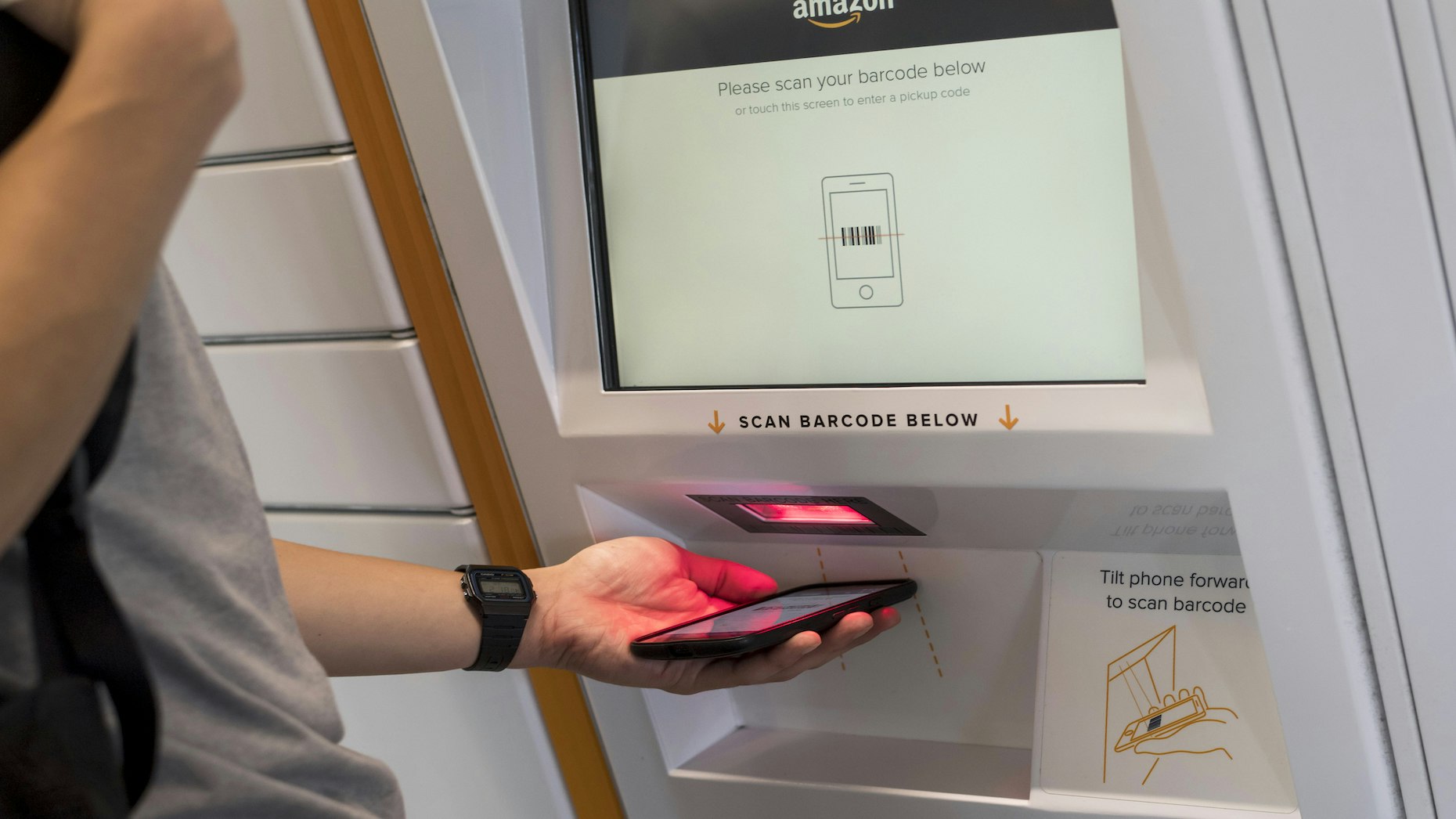 Retrieving a package from an Amazon locker. Photo by Bloomberg.