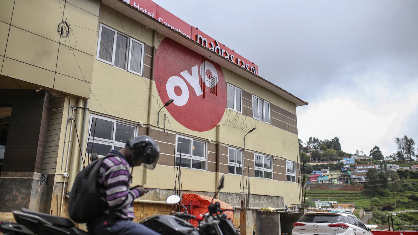 The logo of OYO Rooms is displayed on a hotel in Tamil Nadu, India. Photo by Bloomberg.