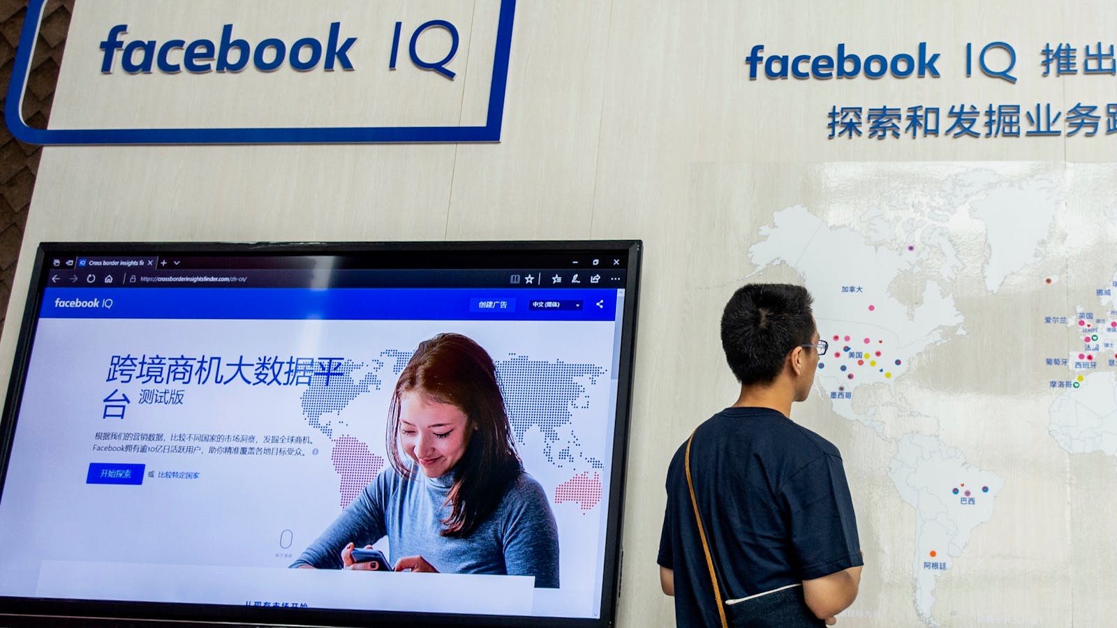 A visitor to a Facebook stand at an exhibition in Shanghai last November. Photo by AP