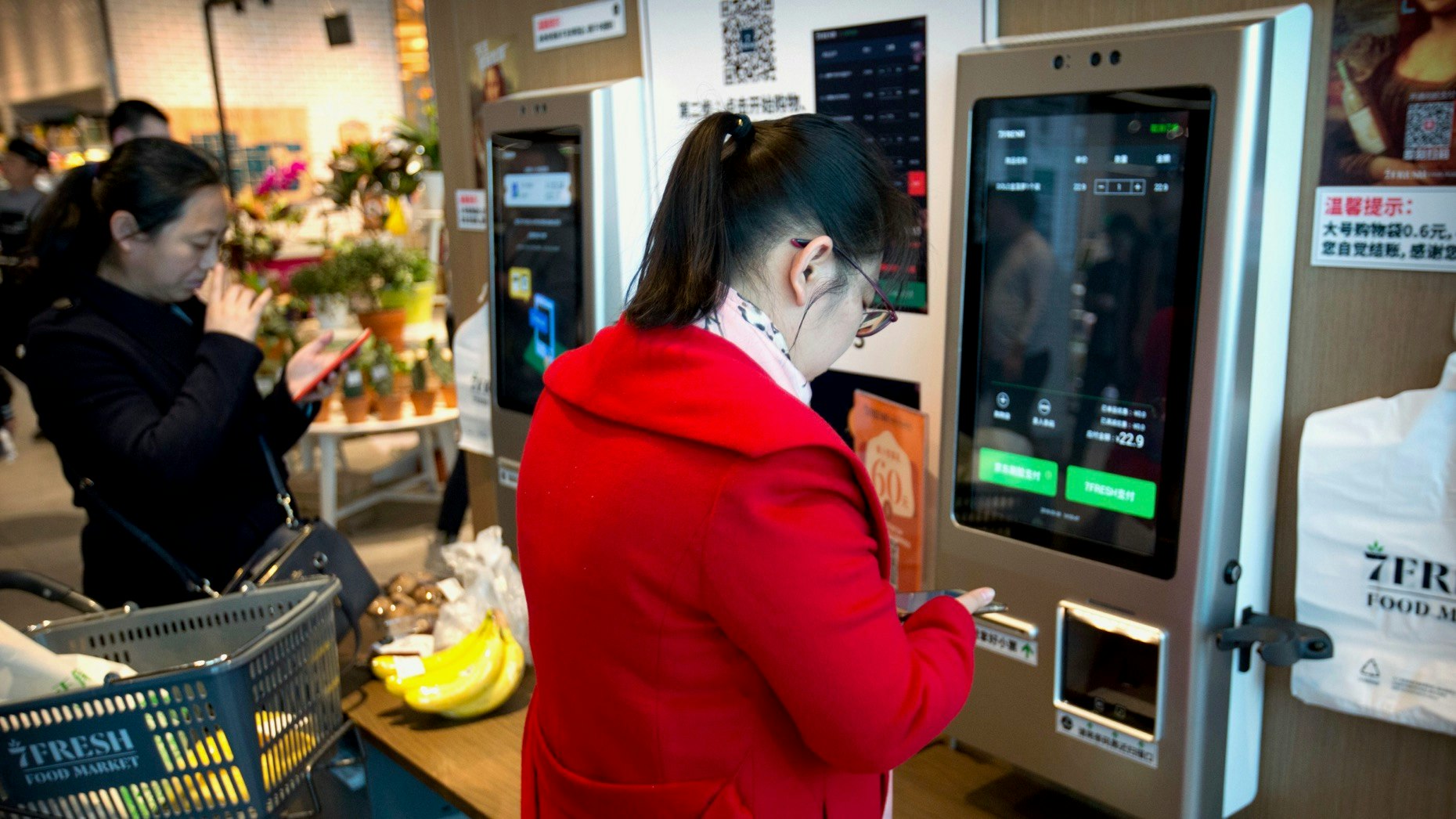 Customers in Beijing used JDPay electronic payment apps on their smartphones last year to pay at a 7FRESH grocery store operated by JD.com. Photo: AP