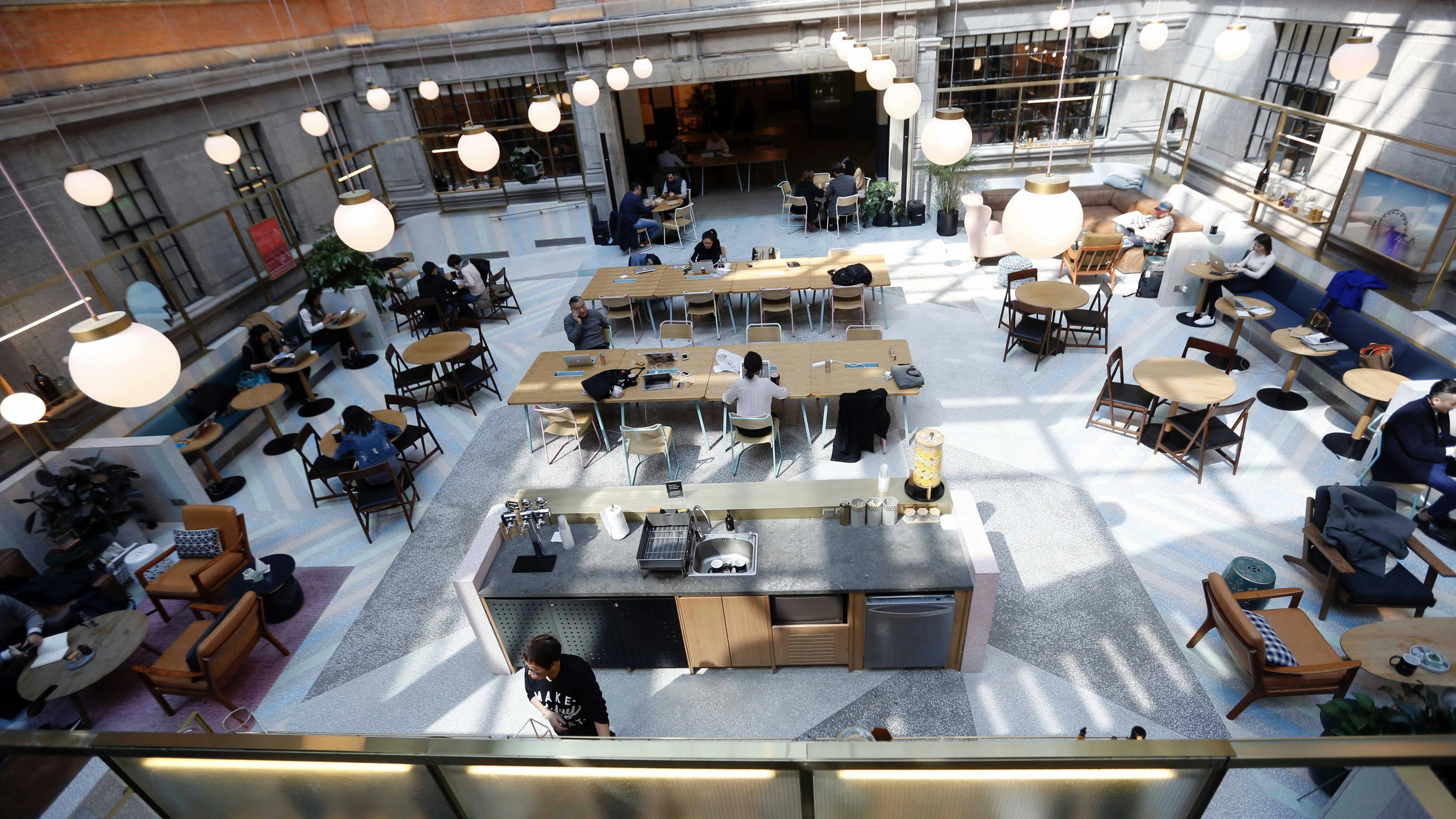 Chinese workers at a WeWork in Shanghai in 2017. Photo by AP
