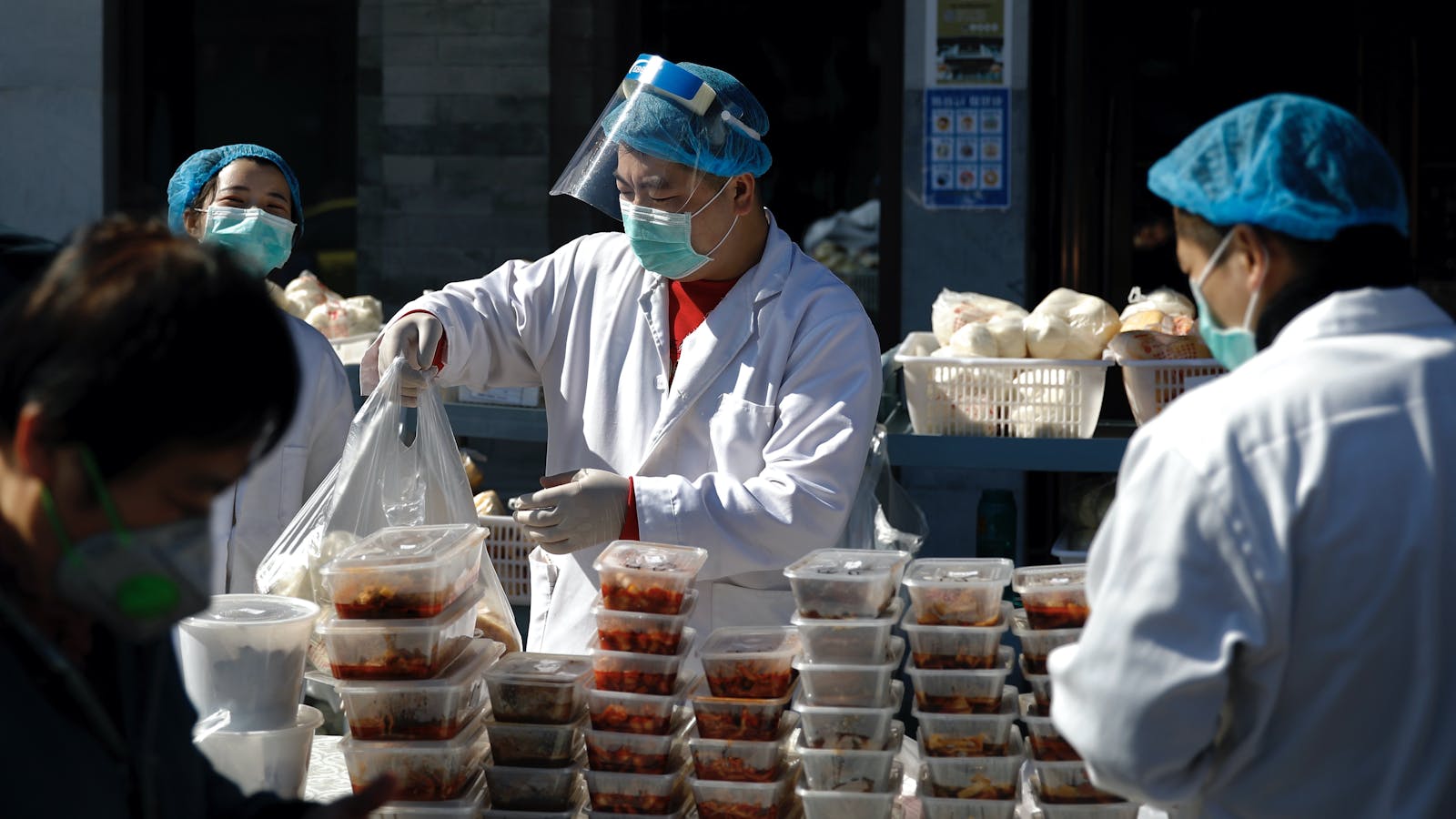 Workers at a Beijing restaurant packing takeout orders on Sunday. Photo by AP