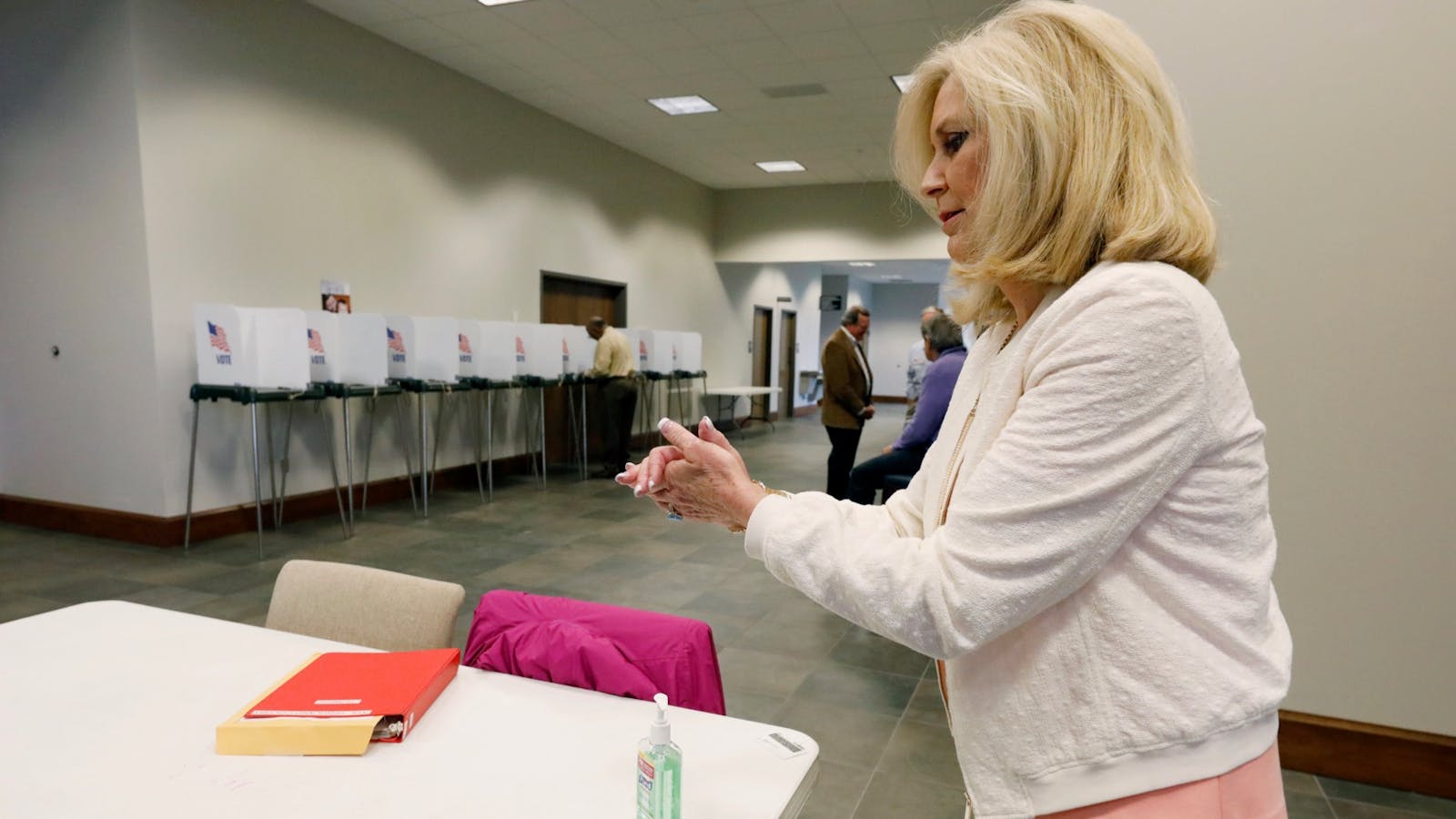 Mississippi Republican Attorney General Lynn Fitch uses hand sanitizer  after voting in the party presidential primary on March 10. Photo: AP