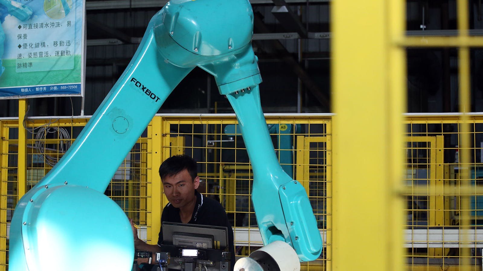 Testing for Foxconn's industrial robots "Foxbot" are performed at Foxconn factory in Longhua town, Shenzhen in 2016. Photo by Getty Images.
