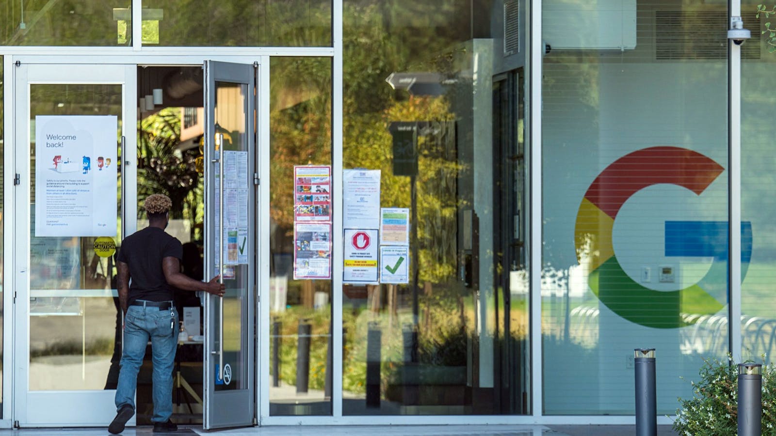 A person walks into a building at the Google campus in Mountain View, California, on Monday, July 27, 2020. Photo by Bloomberg