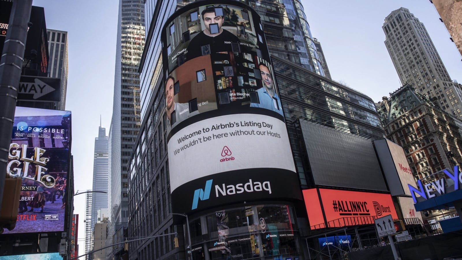 Airbnb's founders displayed on Nasdaq's Times Square screen in New York today. Photo by Bloomberg