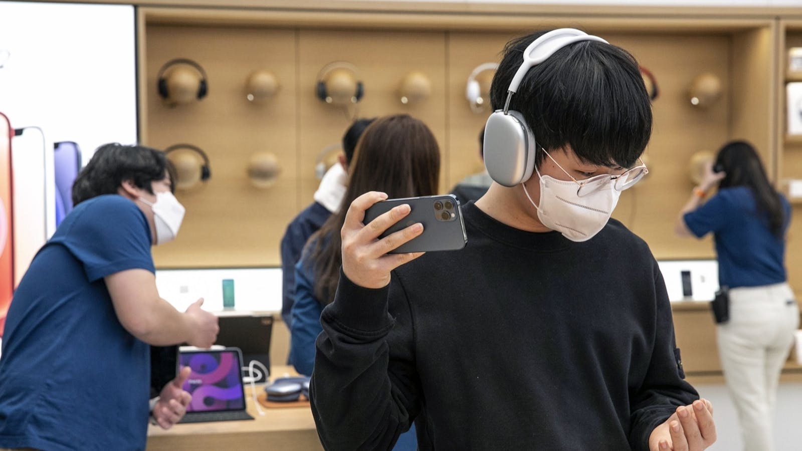 A customer wearing a pair of AirPods Max headphones at an Apple store in South Korea. Photo by Bloomberg