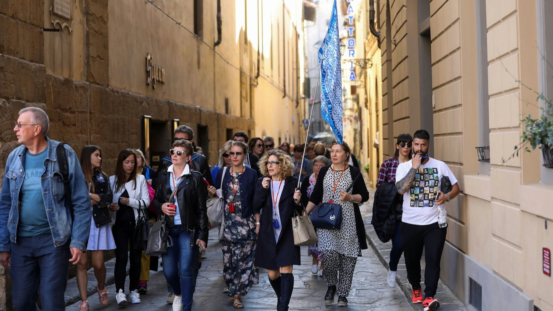Tourists followed a tour guide through a backstreet in Florence, Italy, in 2017. Photo: Bloomberg