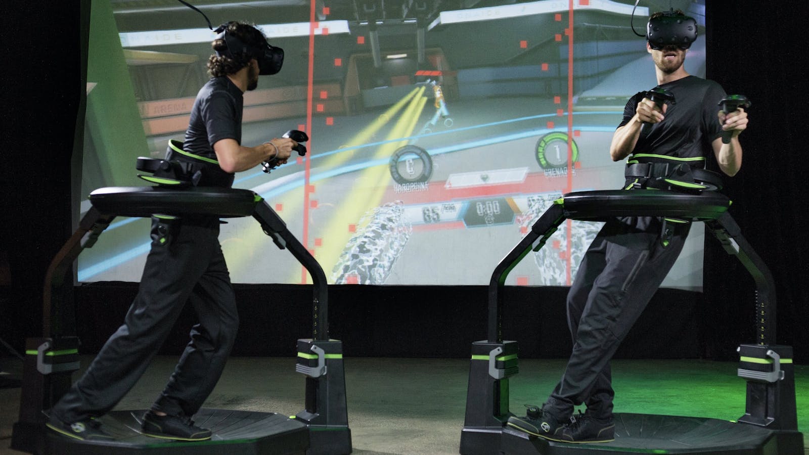 Two VR players using Virtuix Omni Pro treadmills and HTC Vive headsets. Photo by Virtuix