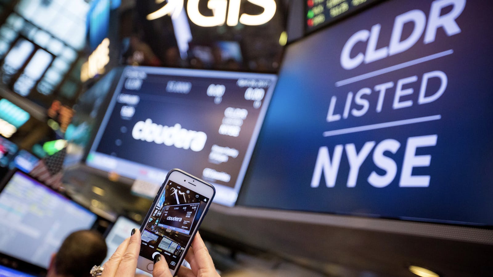 Someone taking a photo of Cloudera signage when the company went public at the New York Stock Exchange in 2017. Photo by Bloomberg