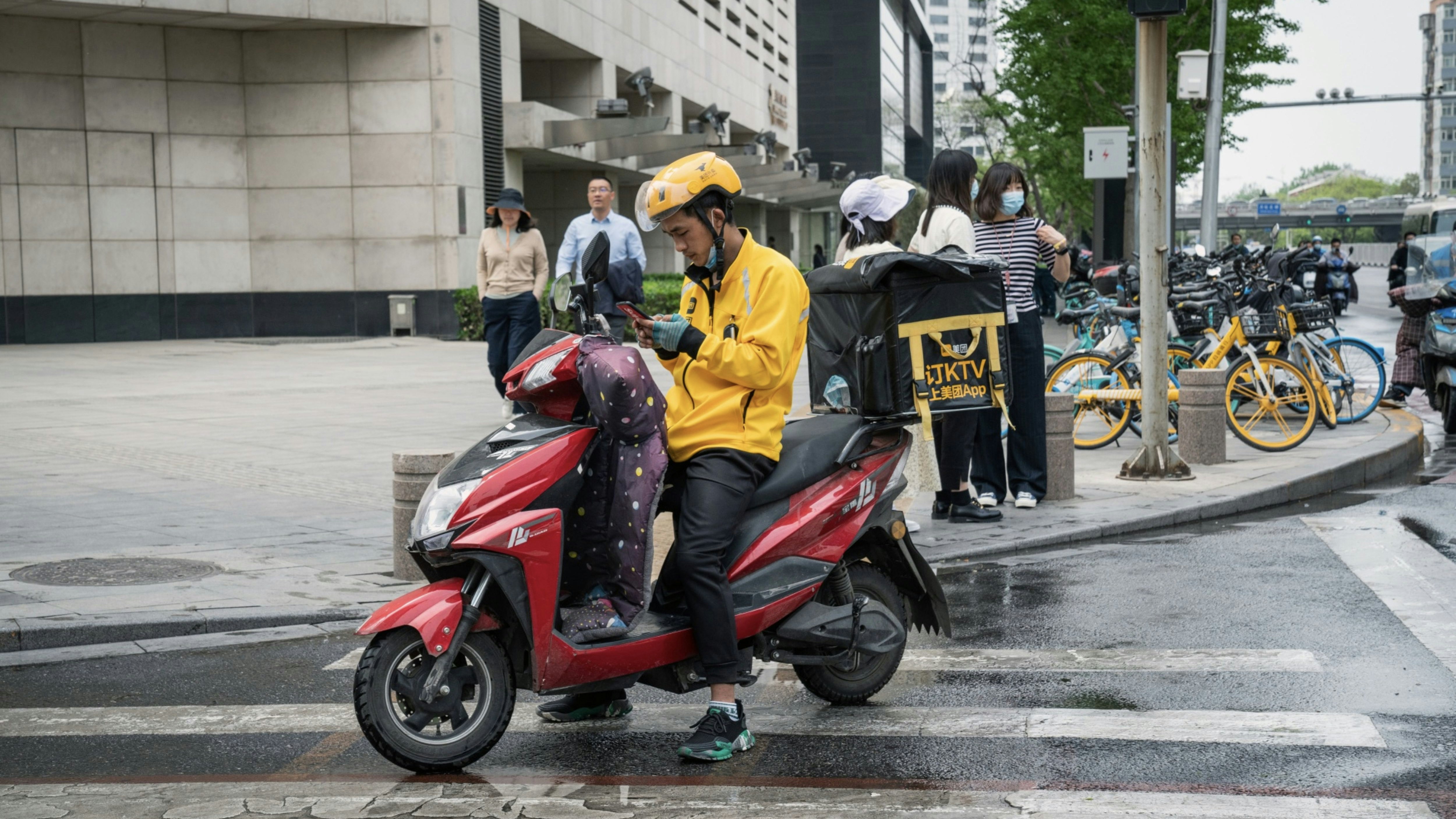 A Meituan food delivery courier in Beijing in April. Photo by Bloomberg.