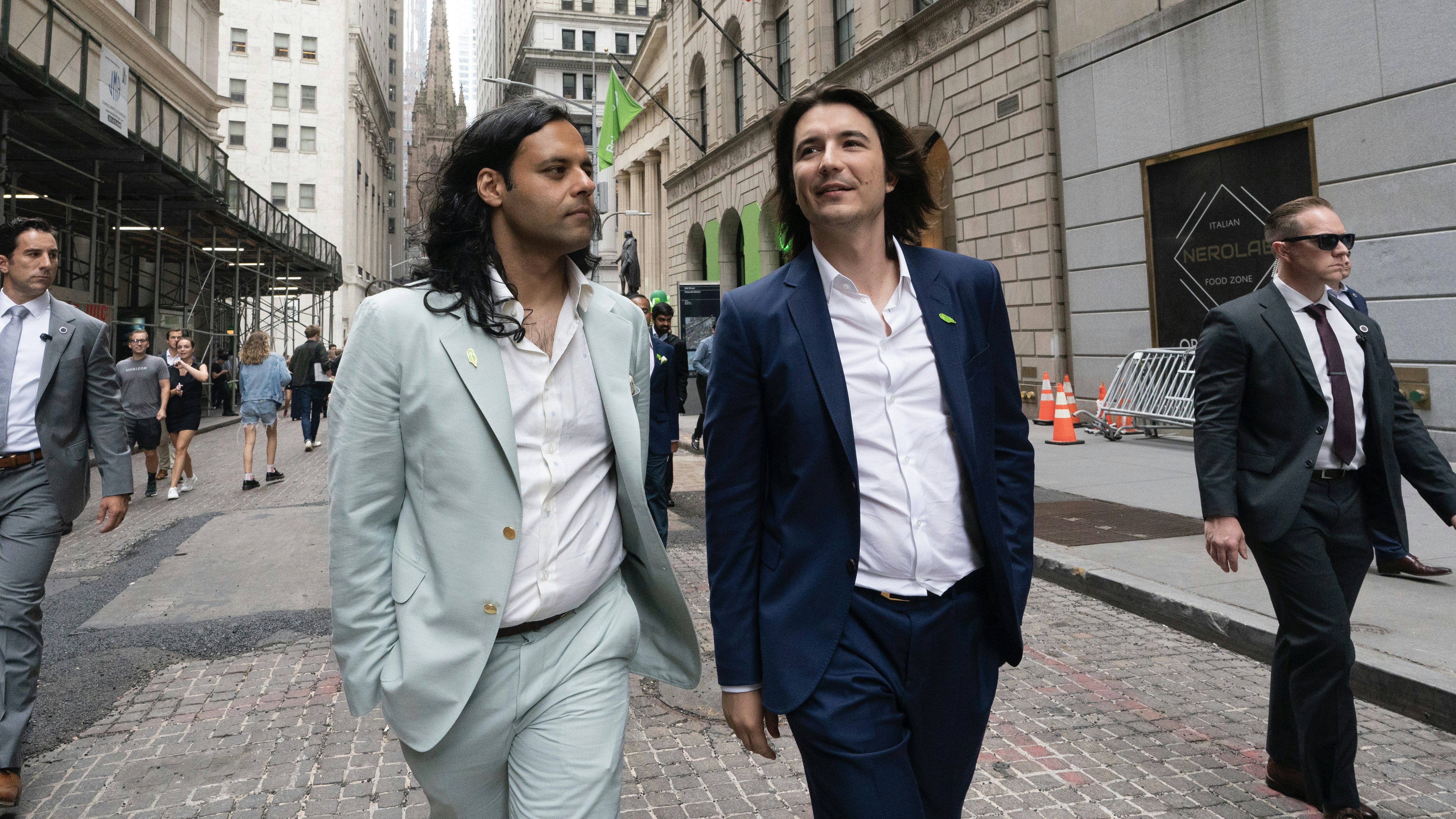 Robinhood co founders Baiju Bhatt, left, and Vladimir Tenev, walk on Wall Street following their company's IPO. Photo by AP